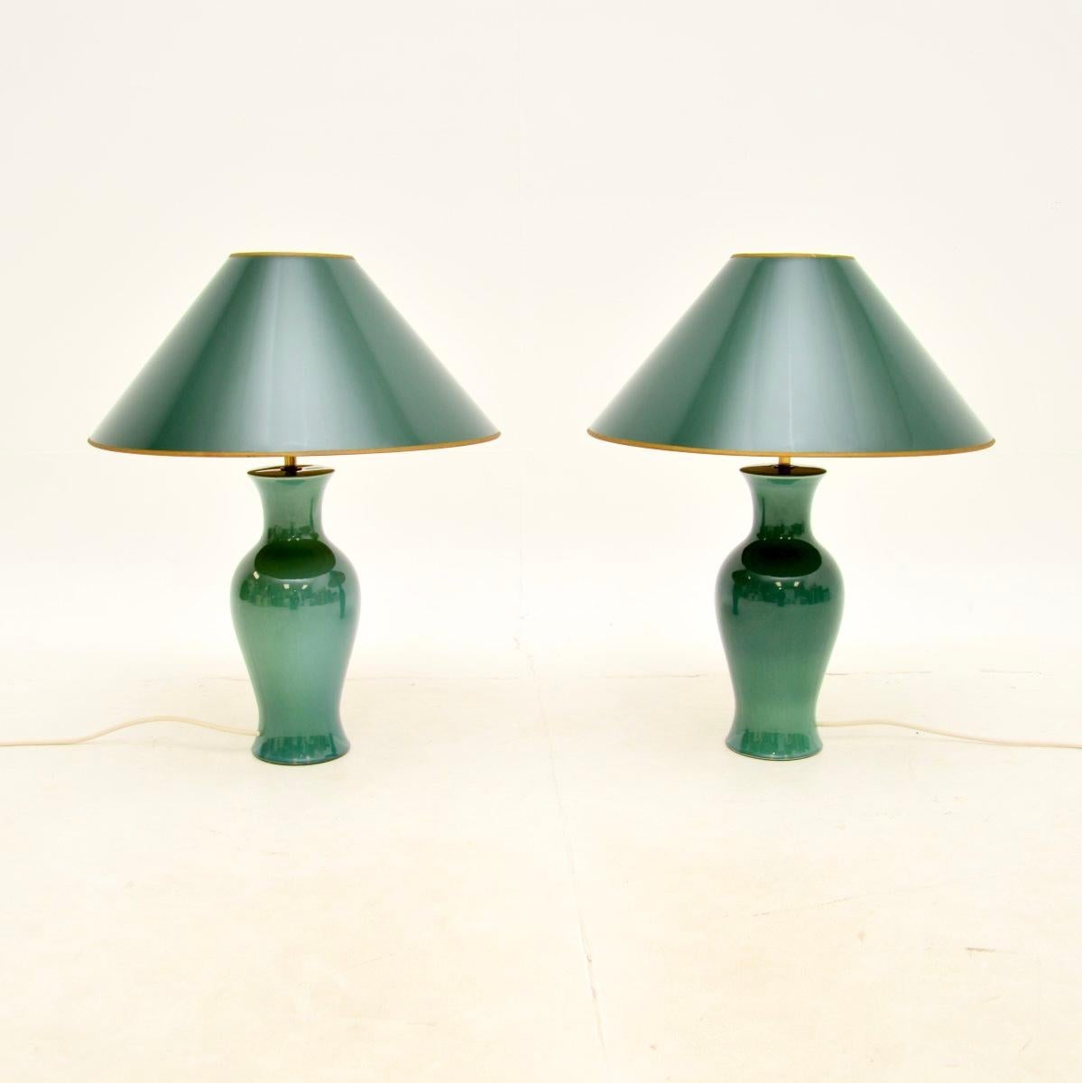 A beautiful pair of vintage ceramic table lamps, made in England and dating from around the 1970’s.

The have a stunning green glaze and are beautifully designed. They are a lovely size and have gorgeous original green conical shades that compliment