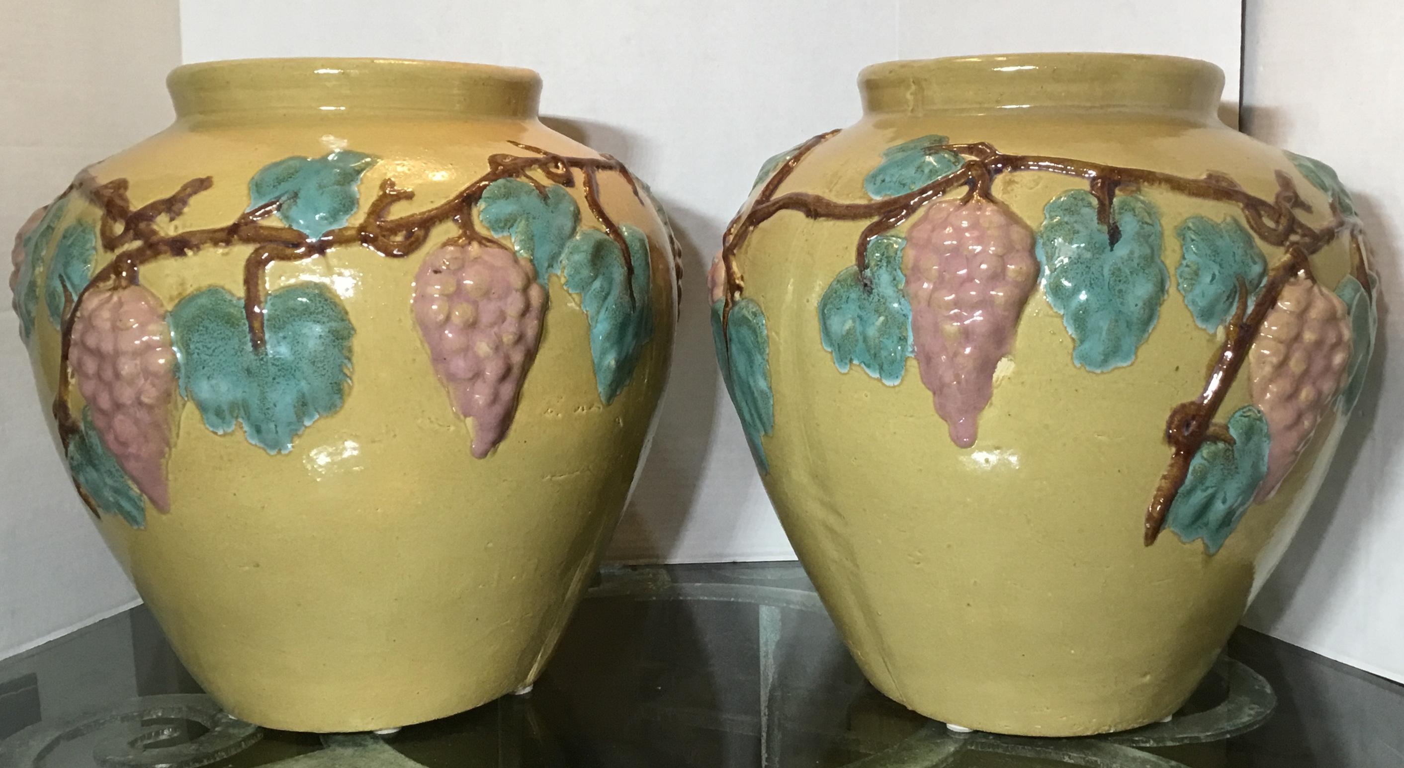 Exceptional pair of vases or planters made of ceramic, hand painted and glazed of grape vine motifs all around, beautiful colors. Could be used as planters or just decorative pair of vases.
The opening size is 7”.5. Great object of art for