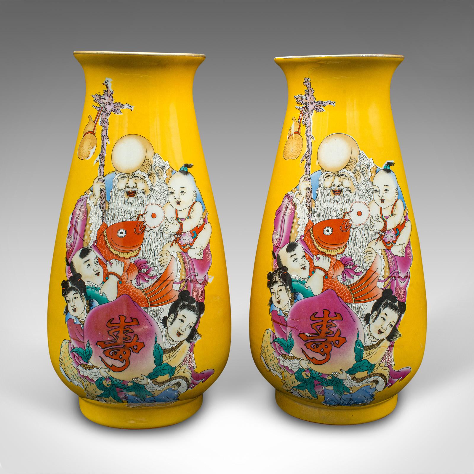 This is a pair of vintage character vases. A Chinese, ceramic baluster urn with figural decor, dating to the Art Deco period, circa 1940.

Striking colour and with distinctive appeal
Displaying a desirable aged patina and in good order
Deep yellow
