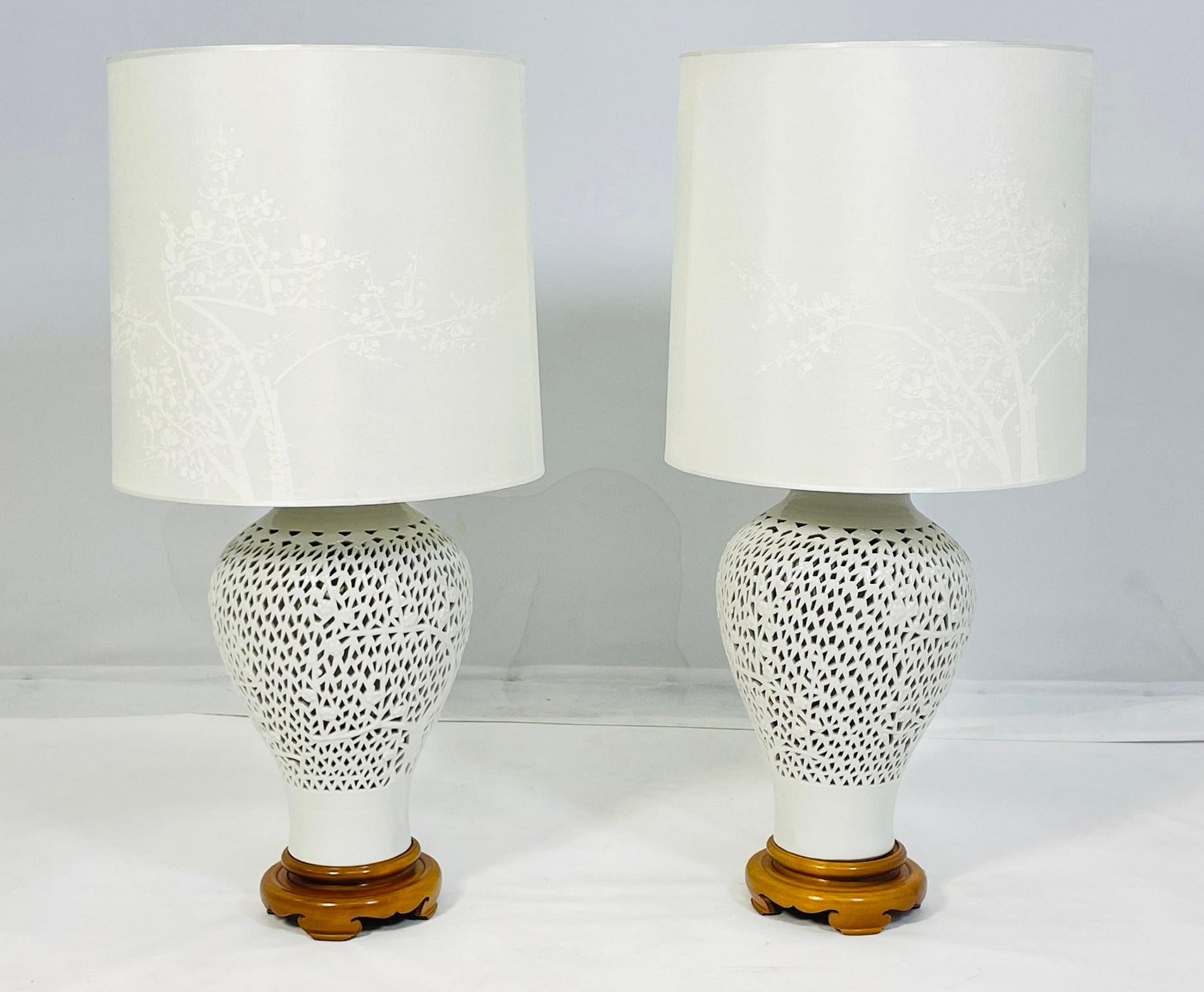 Graziose lampade da tavolo in porcellana reticolata blanc de Chine vintage con motivo floreale a ciliegio. 

Le lampade sono grandi e molto imponenti, anche i paralumi abbinati hanno il disegno dei fiori di ciliegio.

Si tratta di pezzi rari e