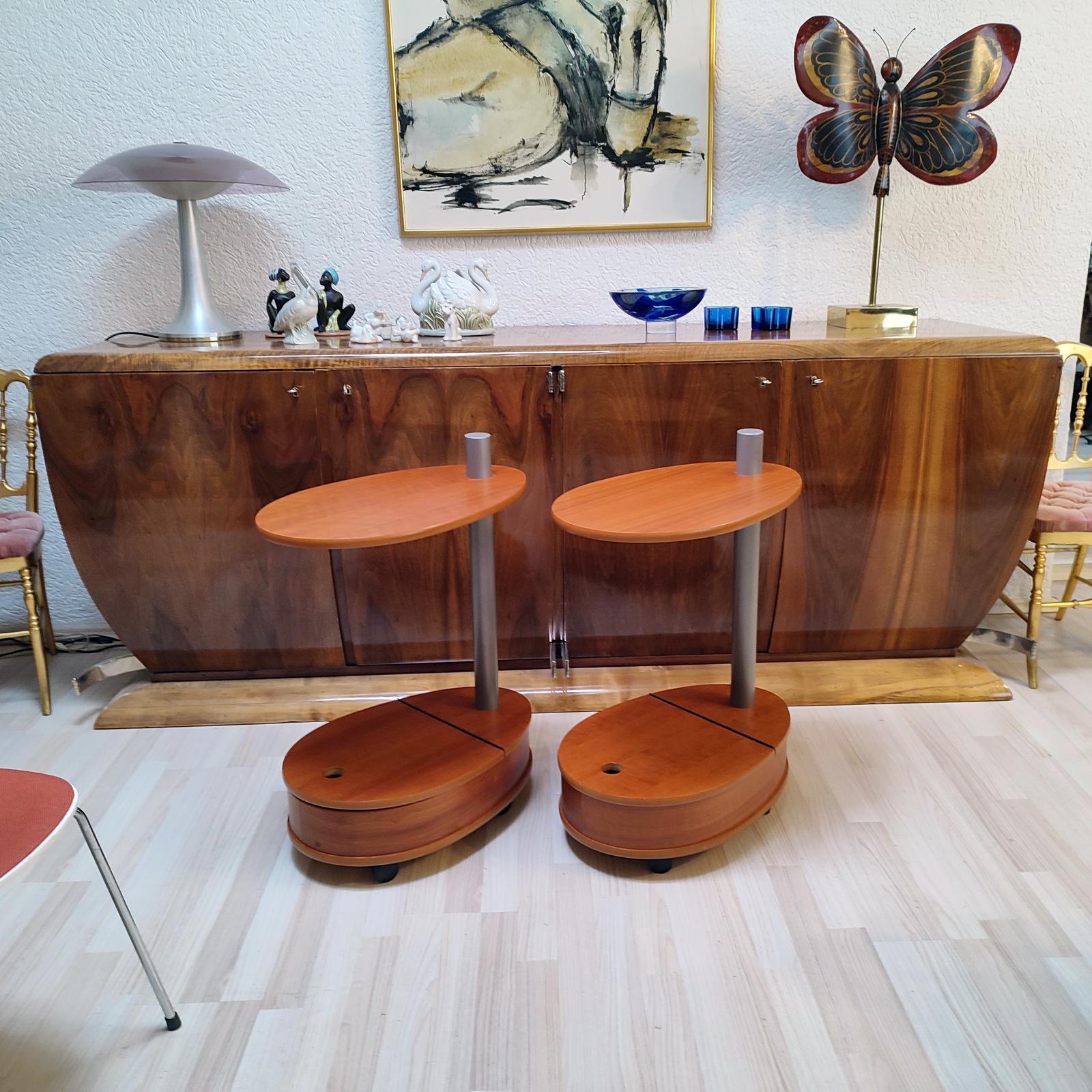 Pair of unusual side tables, mobile, on castors, teak veneer, storage space in the lower part. Very good used condition, normal wear and signs of use.
Dimensions: 55x35x76 cm [21.65x13.78x30 in].

 