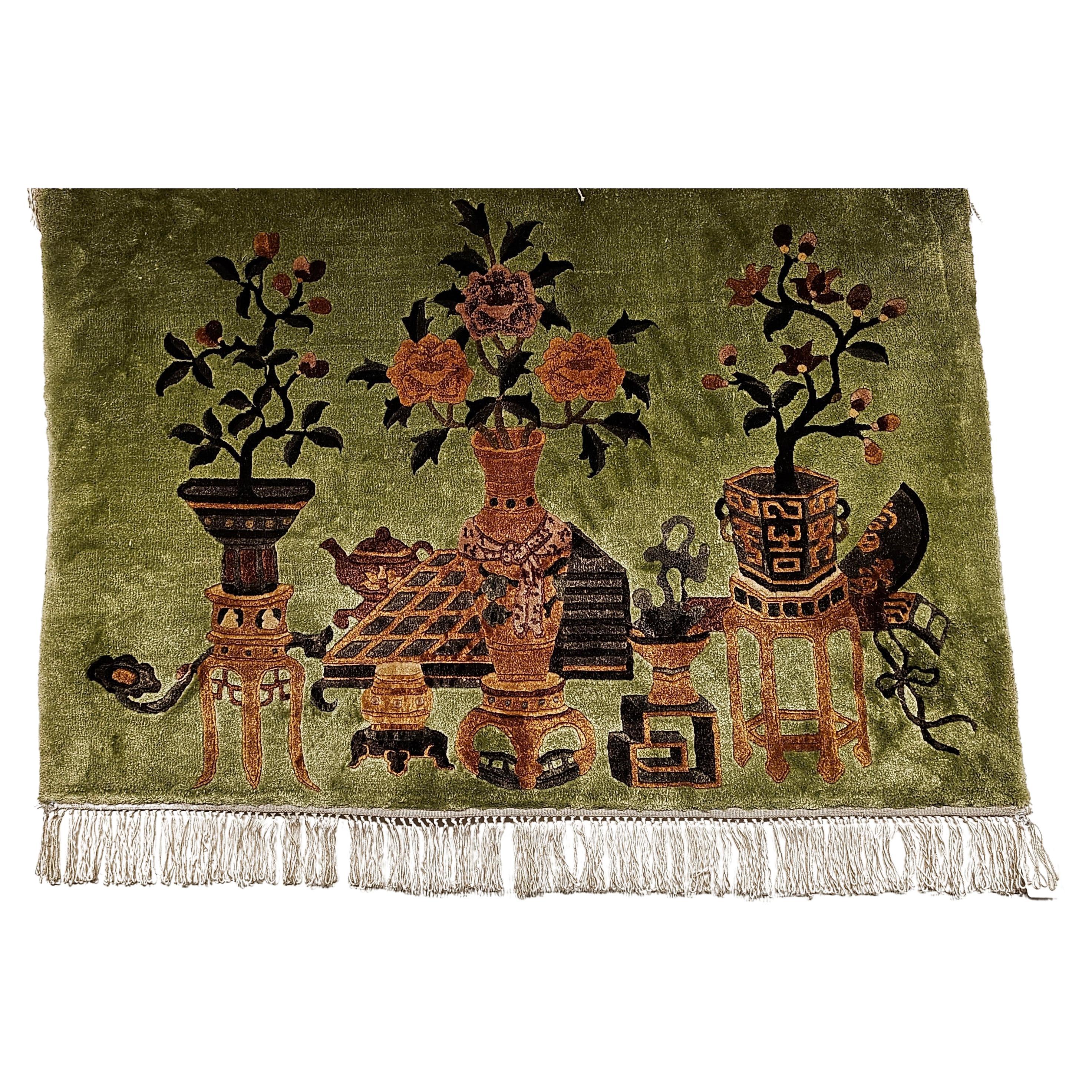  A pair of Chinese Art Deco partial silk pictorial rugs in classic vase pattern from the mid 1900s.  The rugs have a wool pile on a silk foundation.  The background is in a beautiful pale green color with designs of tree flower vases in brown, pale
