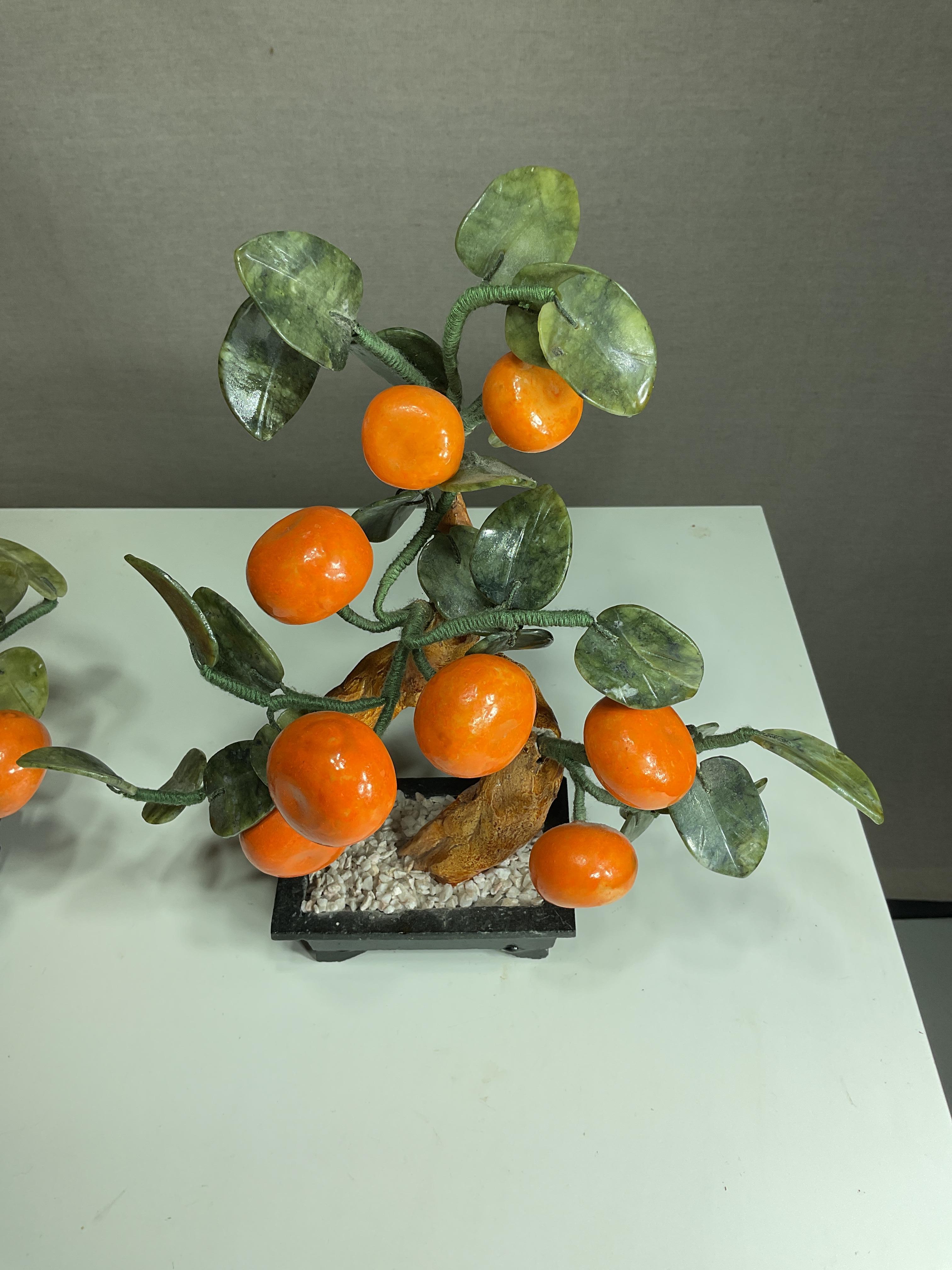 Hand carved vintage bonsai trees
Made of jade and glass
Jade leaves and pots
Glass mandarin fruit that add a burst of color
Made in China in the mid 20th century

Exquisite craftsmanship


