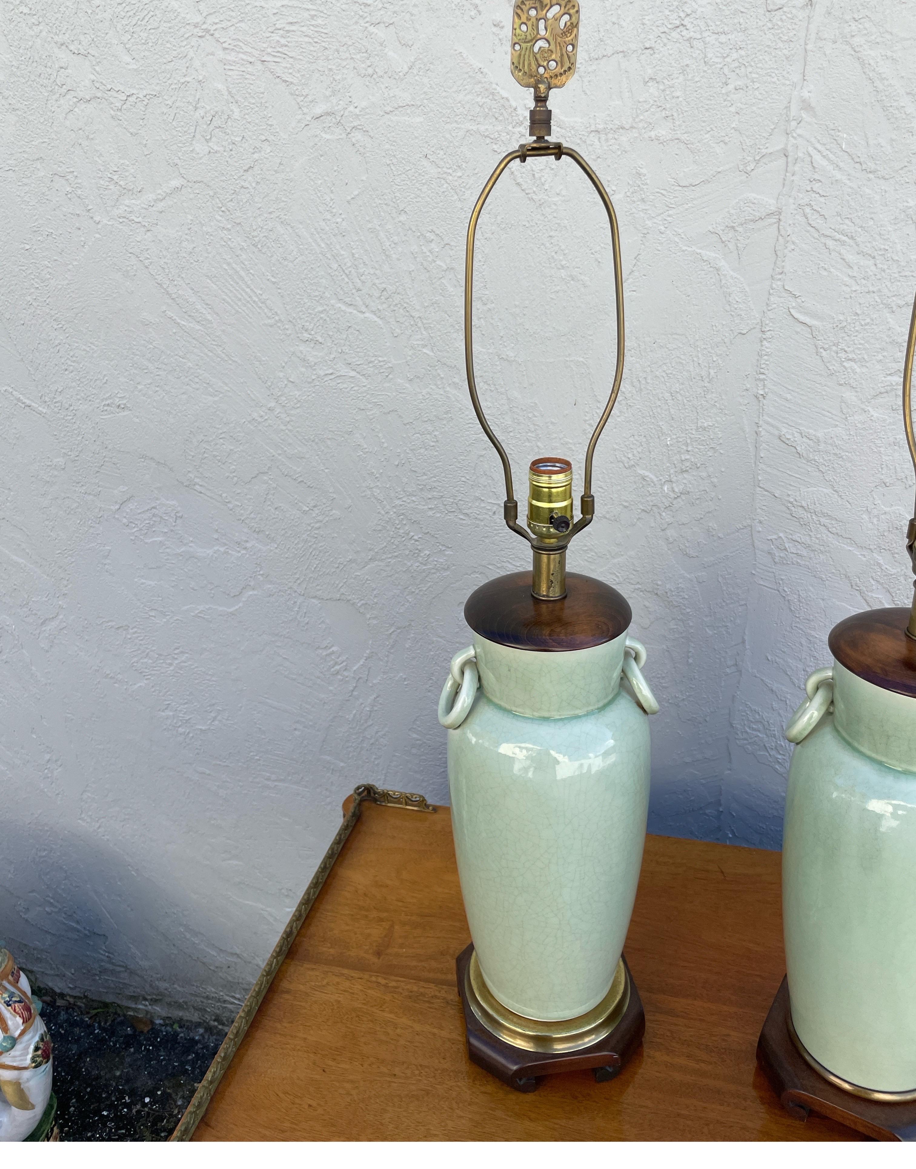 Vintage faux pair of Chinese celadon lamps. There is a slight difference in the bases, which makes me think they were acquired separately. We purchased them from a Palm Beach Estate as is.  We didn't even notice the difference until we were taking