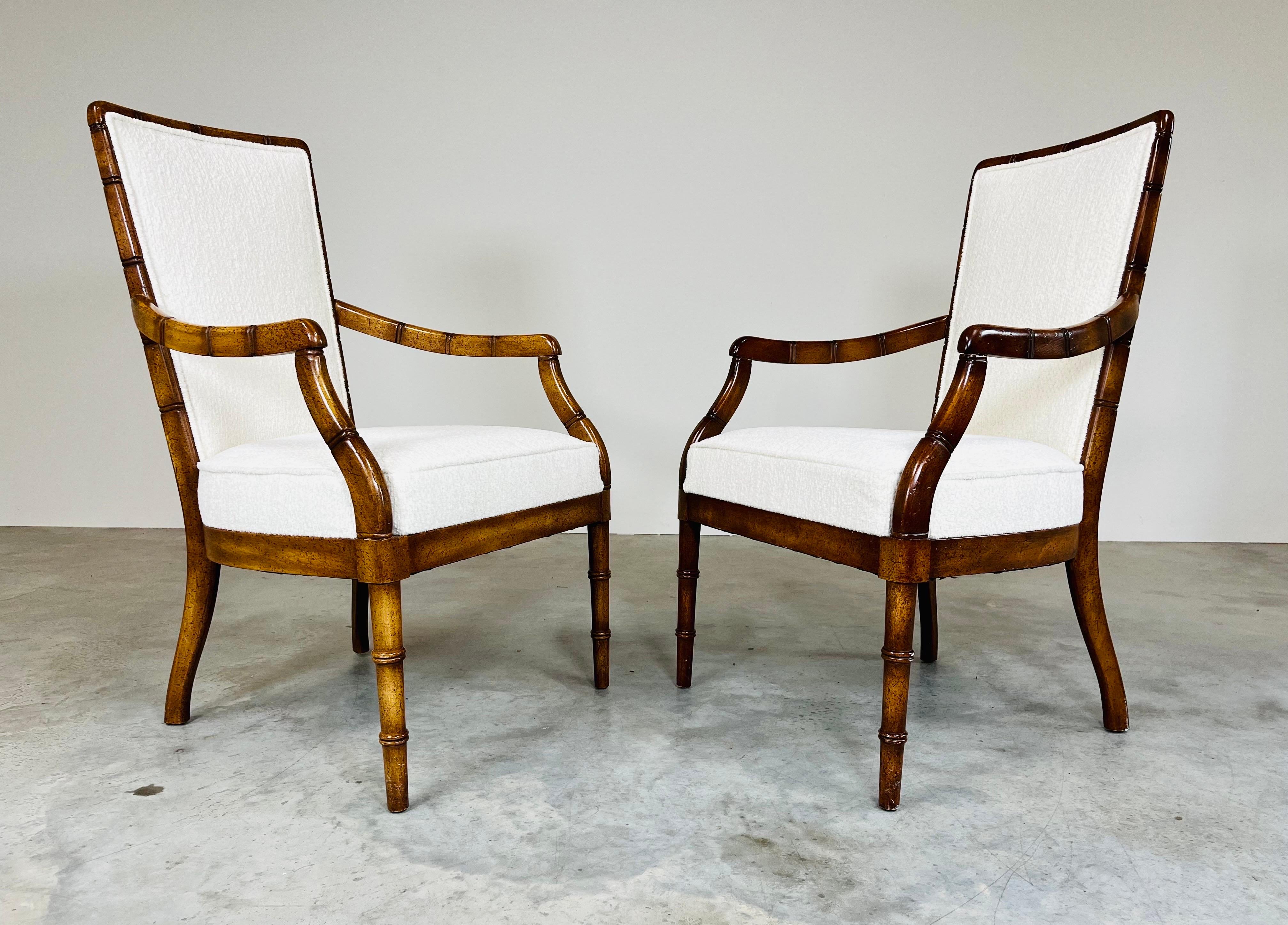 A stunning pair of carved wood faux bamboo Chippendale style armchairs having fresh upholstery and cushions with clean, spun solid wood frames. These chairs are stunning and will ad a regal accent to whatever space they’re placed in. Extremely