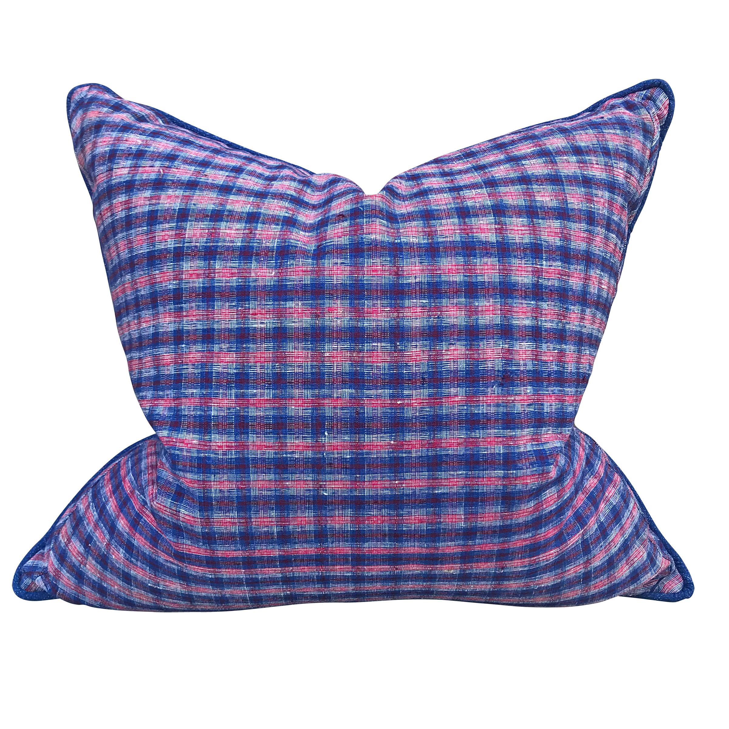 A pair of pillows made from vintage 20th century Chinese cotton panels with an indigo and crimson plaid pattern on one side, and a handwoven indigo cotton pattern on the reverse. With a self welt, and filled with down.