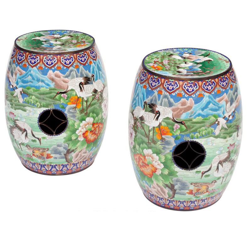 Use extra seating in your den with this pair of colorful garden seats; crafted in China circa 1980, each stool is made of metal with cloisonné and enameled motifs of bird in a landscape throughout. Both seats are in excellent condition with rich