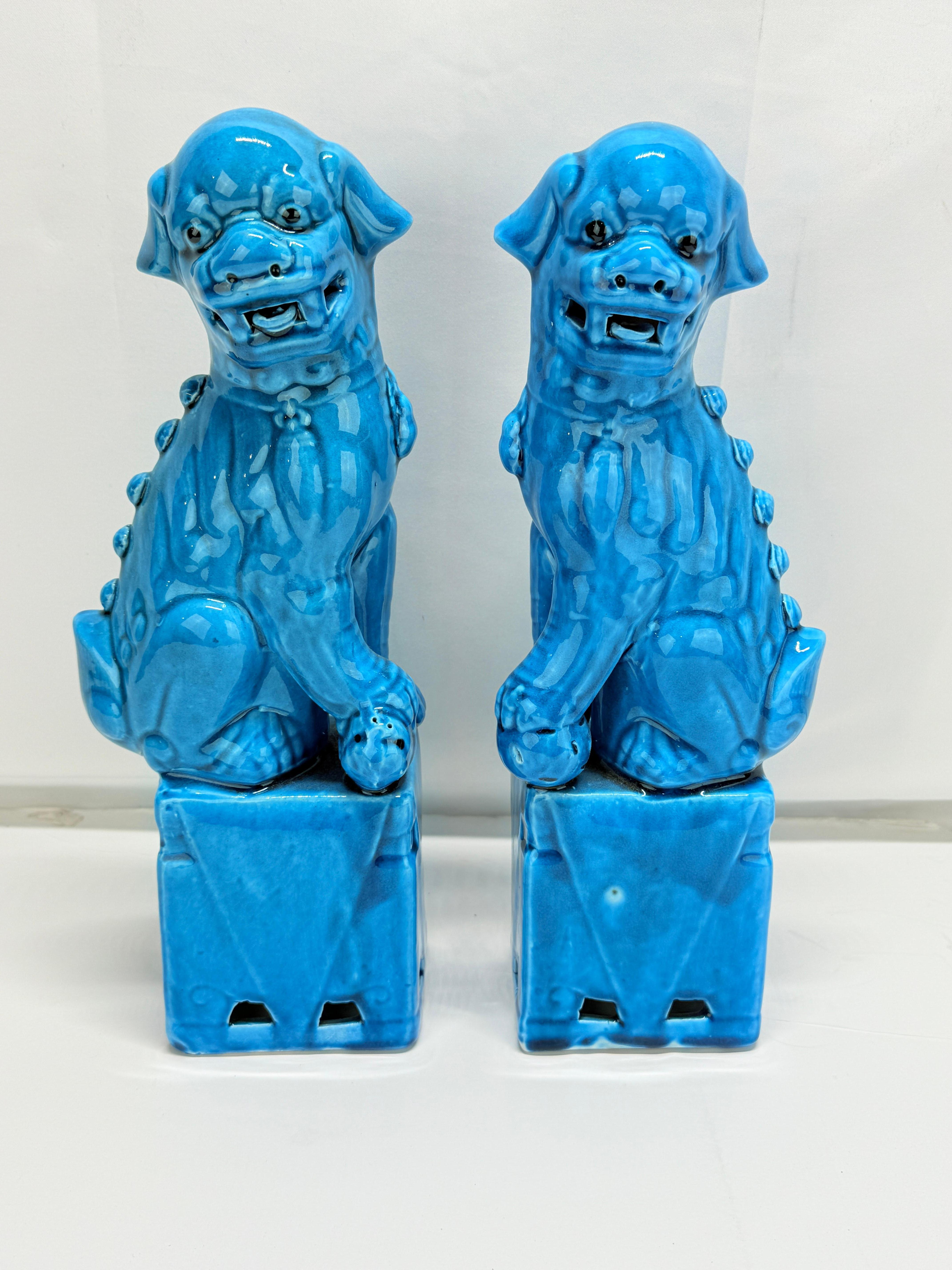This finely modeled pair of porcelain guardian lions—commonly referred to as “Foo Dogs”—is rendered in a brilliant turquoise glaze, a hallmark of Chinese decorative ceramics popular during the late Qing Dynasty (circa 1880–1912) and into the early