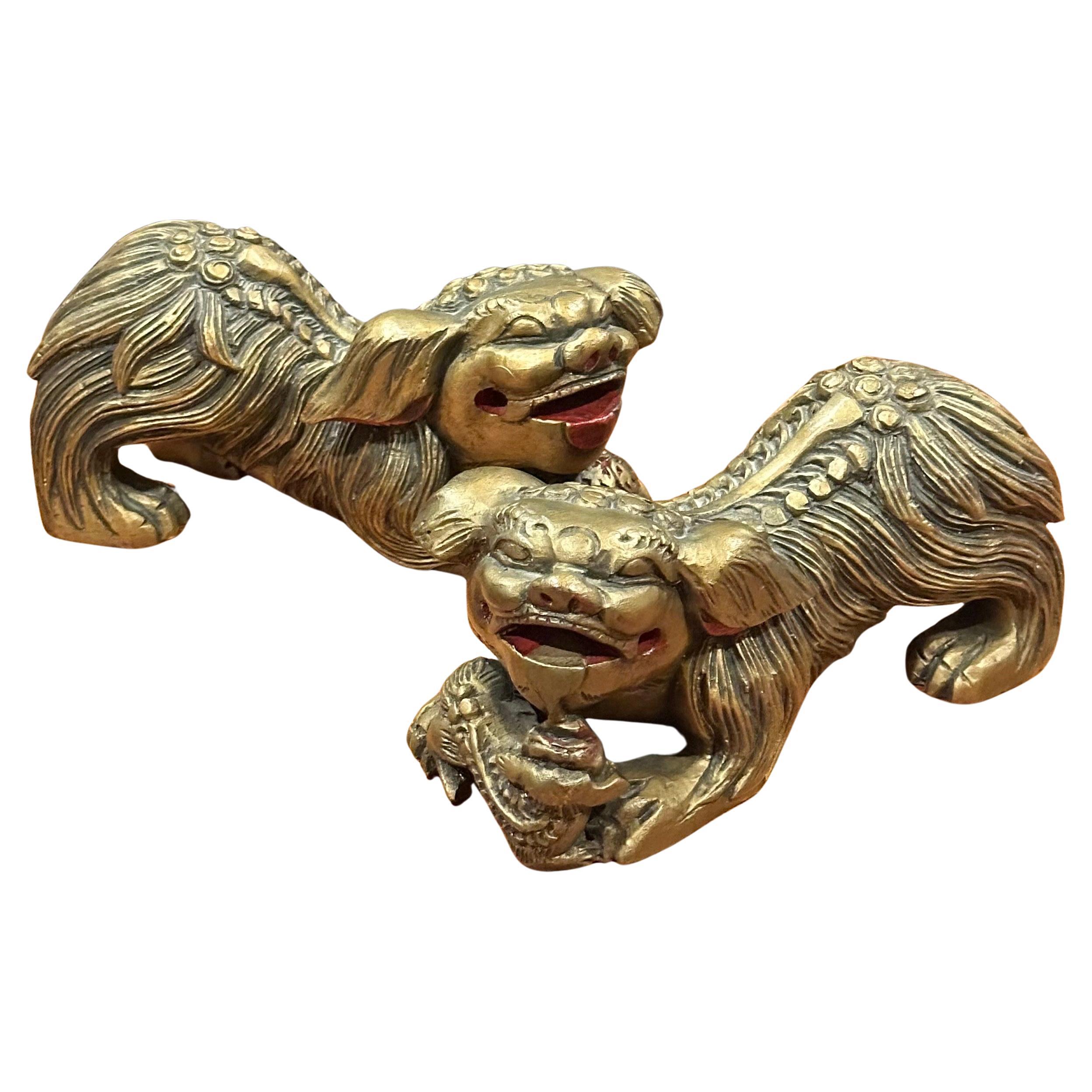 Great pair of vintage Chinese gold gilt wood carved Foo Dogs, circa 1970s. The pair measure 15.5