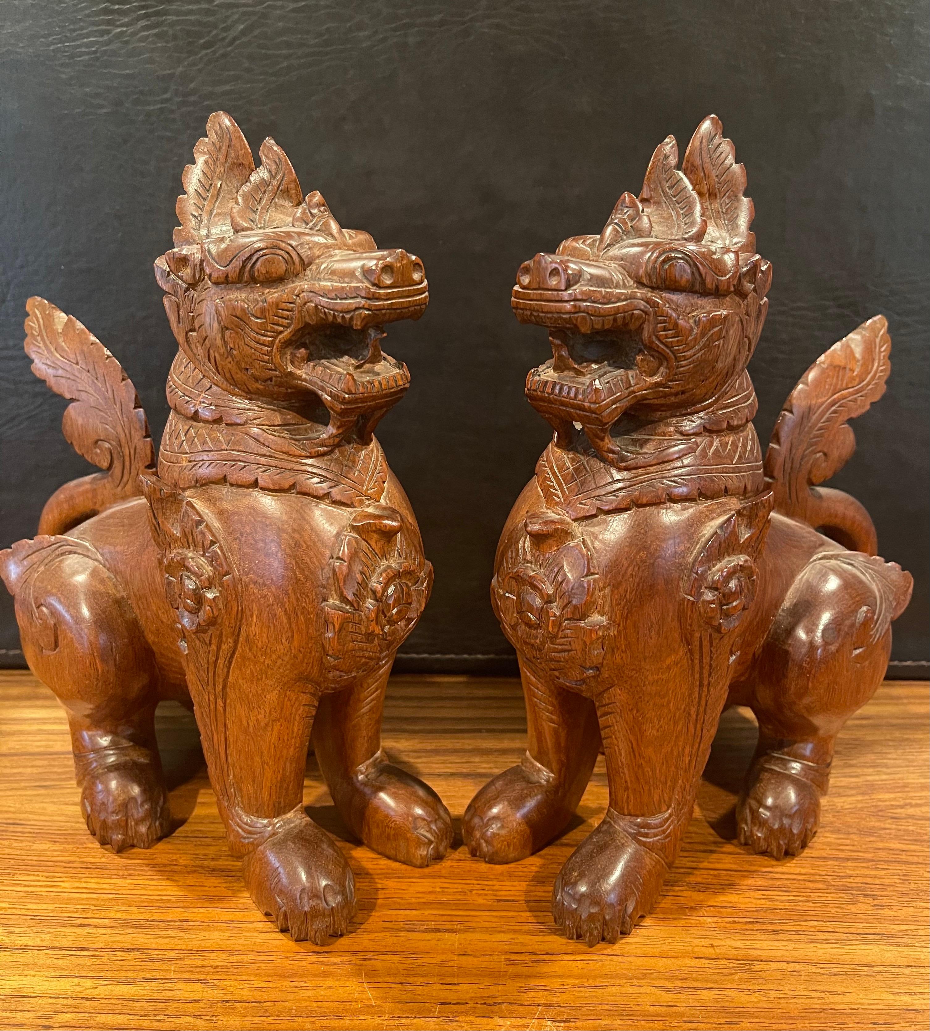A very nice pair of vintage Chinese hand carved hard wood foo dogs or bookends which I believe are made from mahogany or elm, circa 1970s. The dogs are in very good condition and measure 4.5