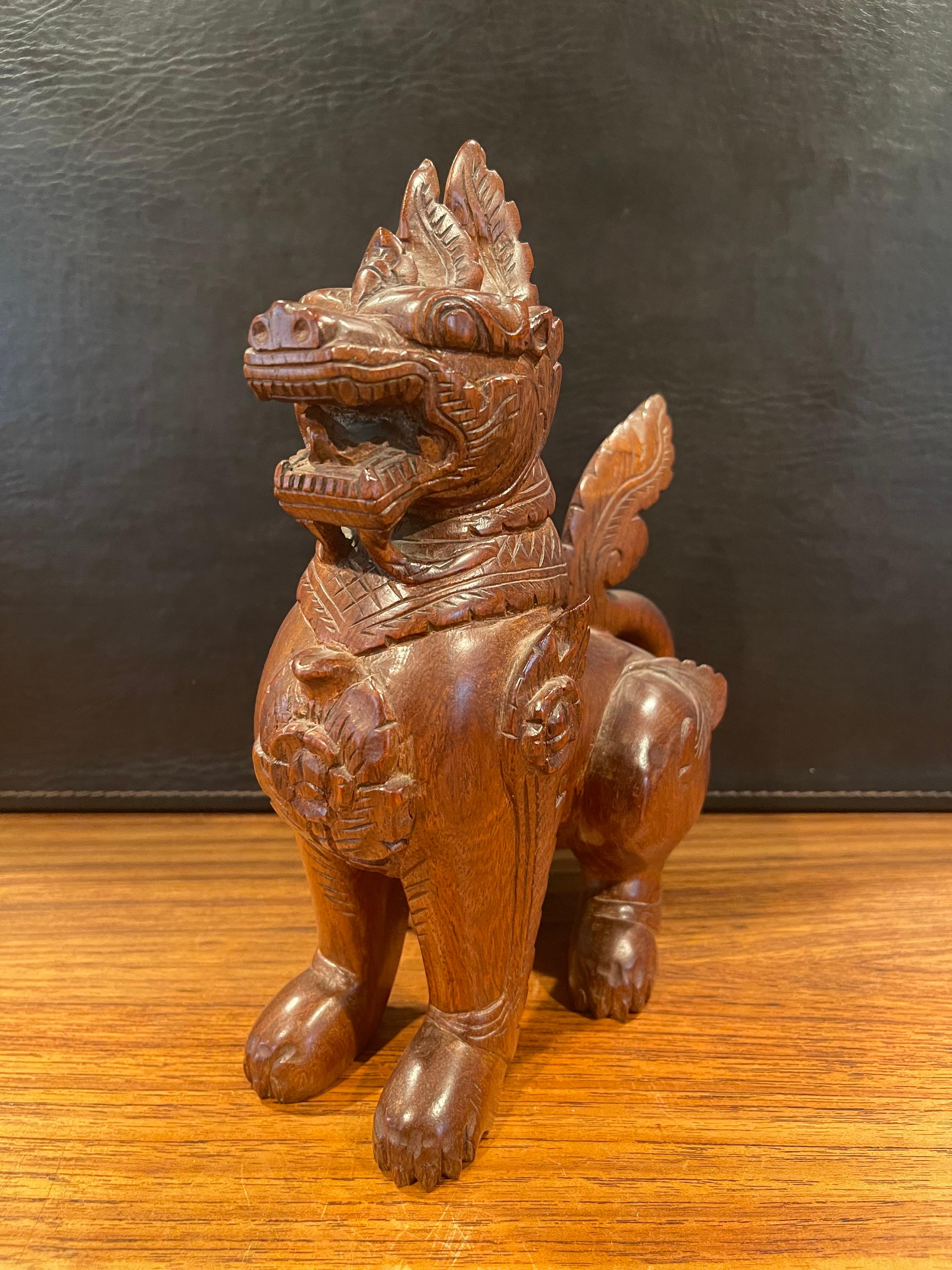 Pair of Vintage Chinese Hand Carved Hard Wood Foo Dogs In Good Condition For Sale In San Diego, CA