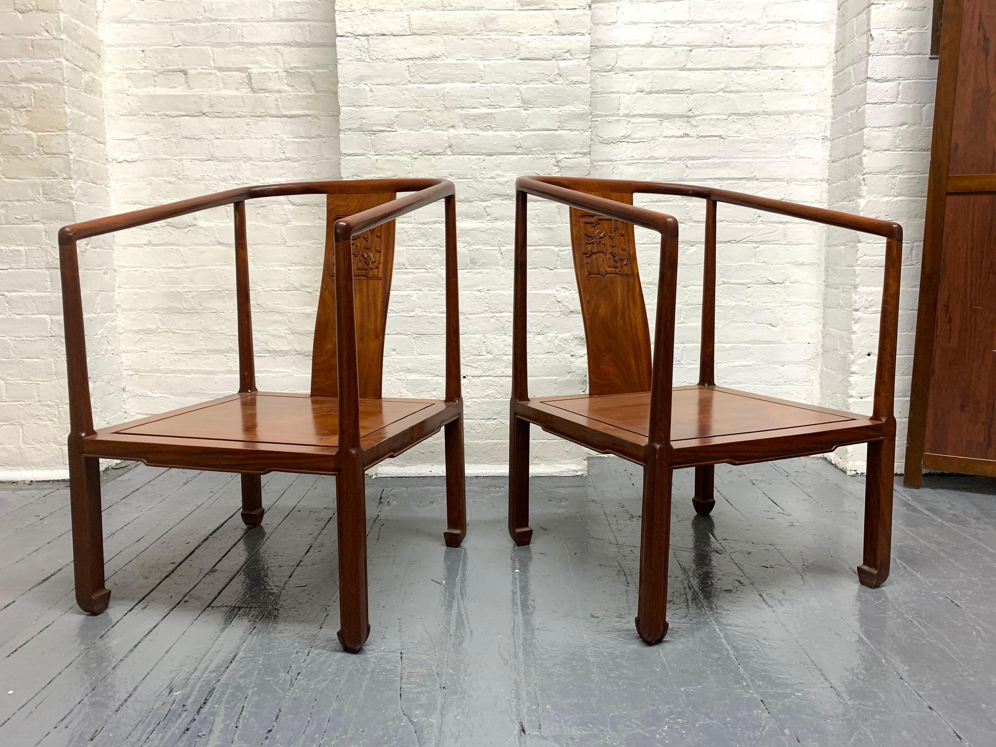 Pair of vintage Chinese rosewood chairs. Has a Chinese relief pattern to the back. Chairs are solid rosewood. Nice pair for an Asian inspired interior.