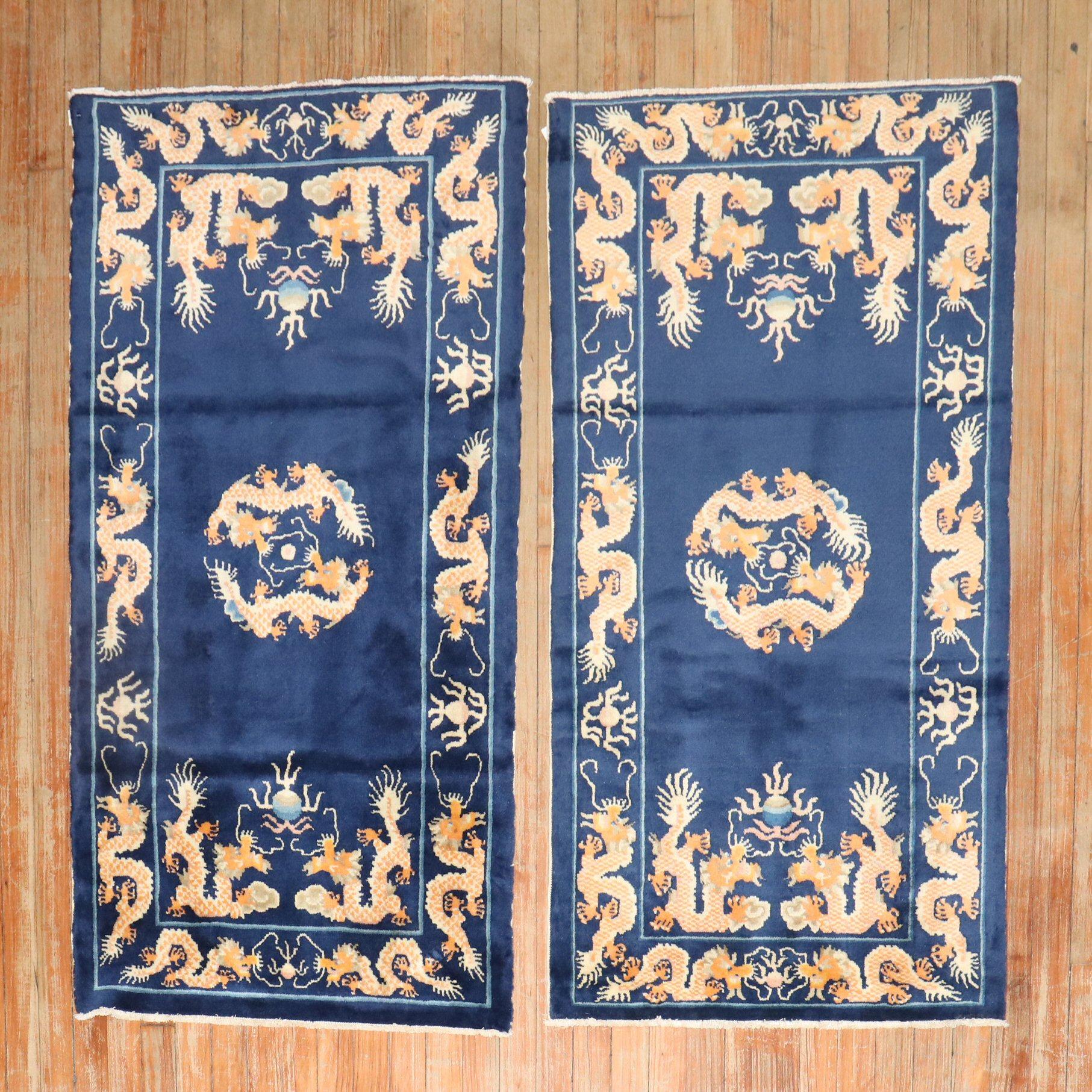 A matching pair of scatter-size Chinese rugs from the 3rd quarter of the 20th century.

Measuring 2'5'' x 4'7'' & 2'3'' x 4'5'' respectively.