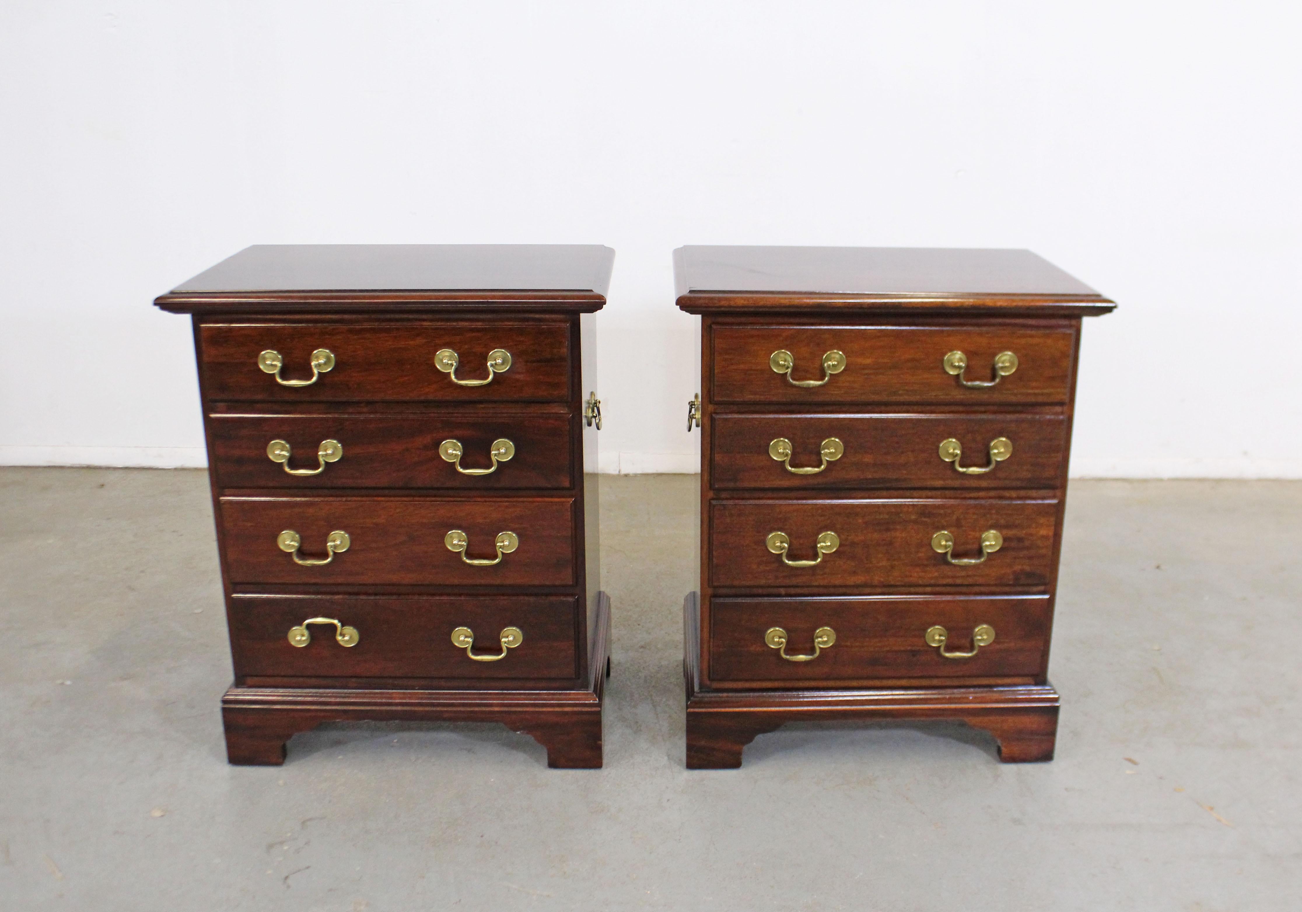 Offered is a pair of vintage Chippendale style nightstands/chests of drawers. They look like they're made by Statton Old Towne, but are unsigned. They're made of solid dark mahogany with brass pulls. Each stand has 4 dovetailed drawers. They're in