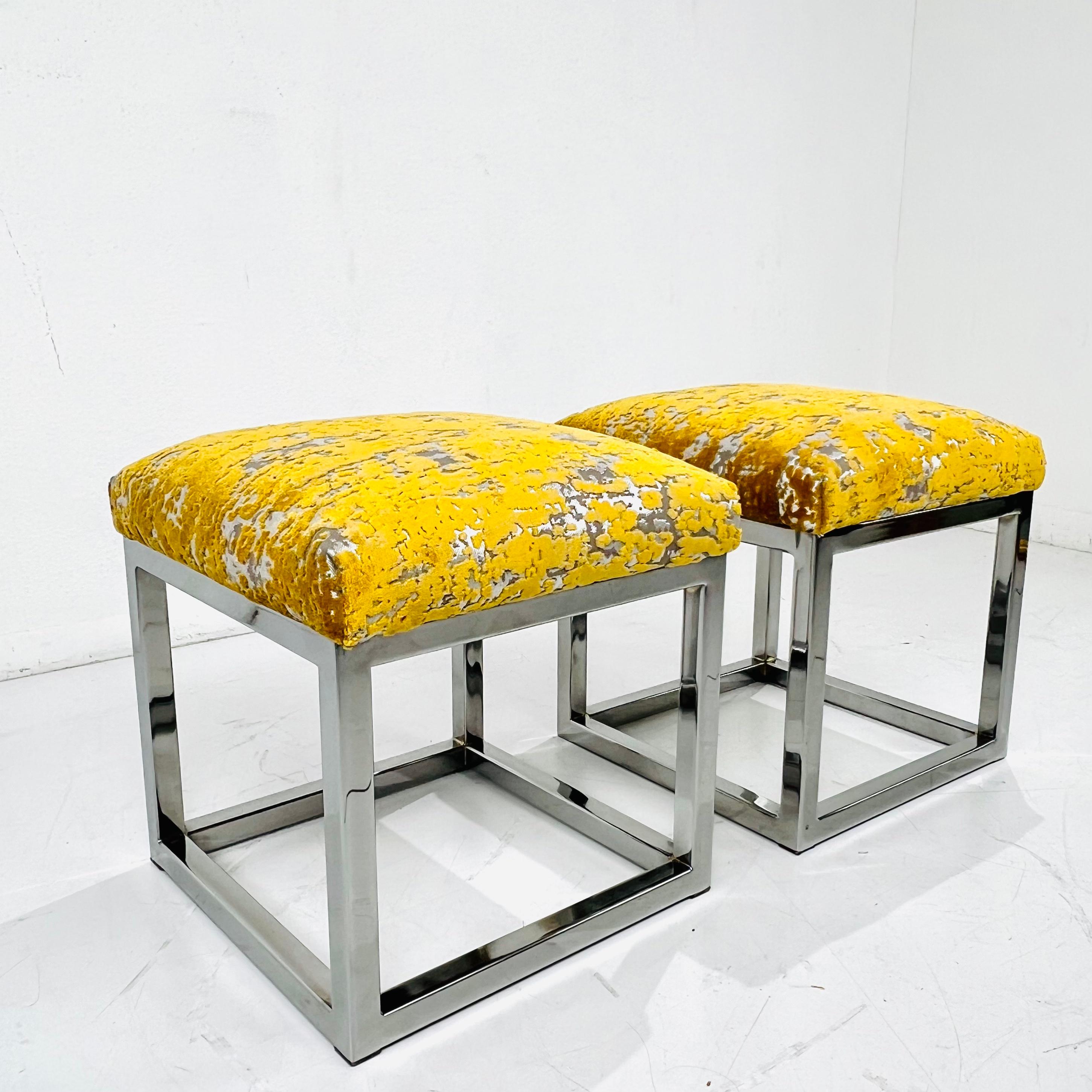 Pair of vintage footstools/ottomans featuring new designer velvet upholstery and sleek chrome frames. Great as extra seating. Frames in good condition with some minor pitting/imperfections to chrome. Upholstery in excellent condition.