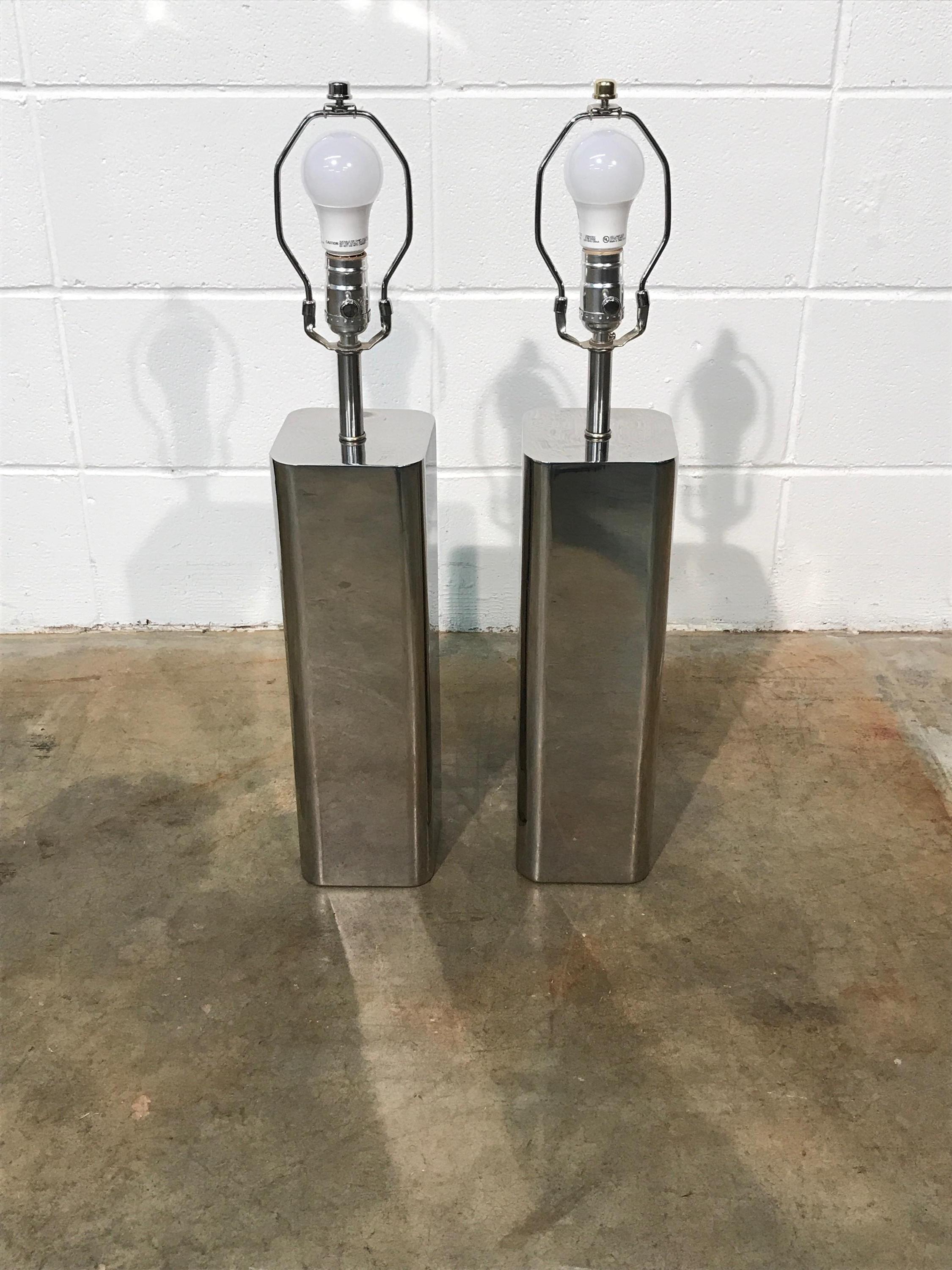 Pair of vintage chrome lamps attributed to Laurel Lamp Co.
These lamps have been fully restored including new wiring, new sockets, new shades, and polished to a mirror shine. No known defects that would detract from value or aesthetics. Ready for