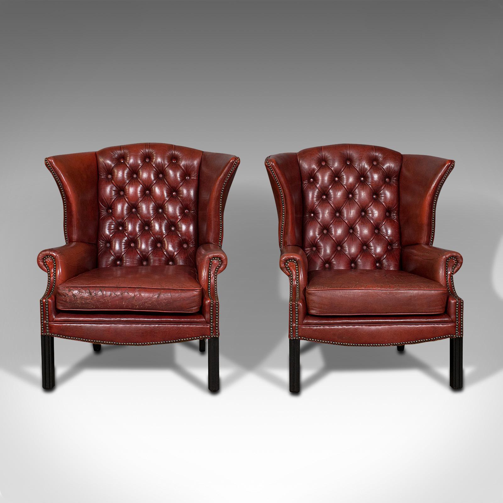 This is a pair of vintage clubhouse wingback chairs. an English, leather button back armchair, dating to the mid 20th century, circa 1950.

Charming club lounge chairs for keeping the fire heat at bay
Displaying a desirable aged patina