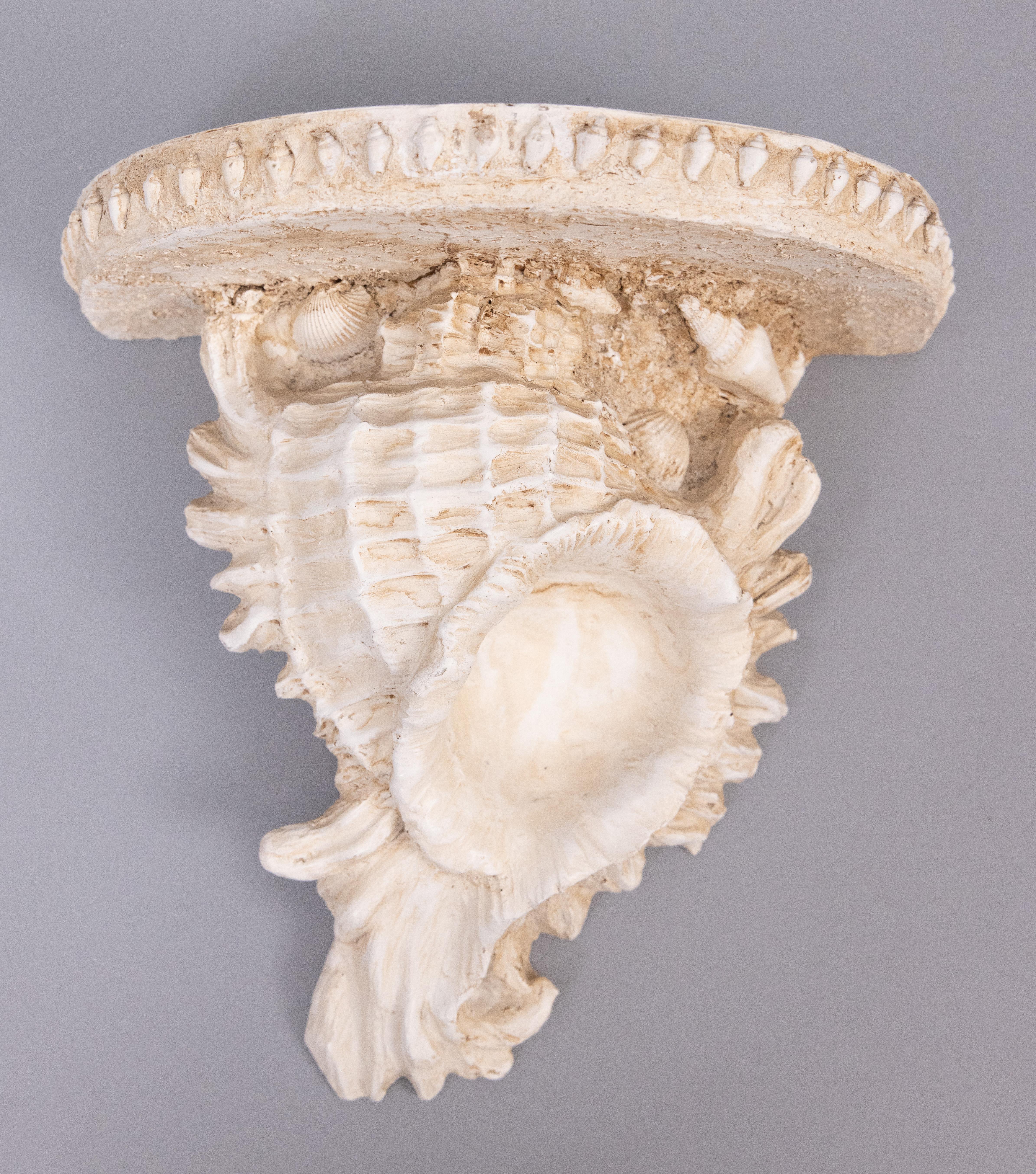 A lovely pair of vintage faux shell shaped wall brackets or shelves with a Nautical seashell encrusted design. They are perfect for displaying decorative collectibles or fabulous on their own.

DIMENSIONS
9.75