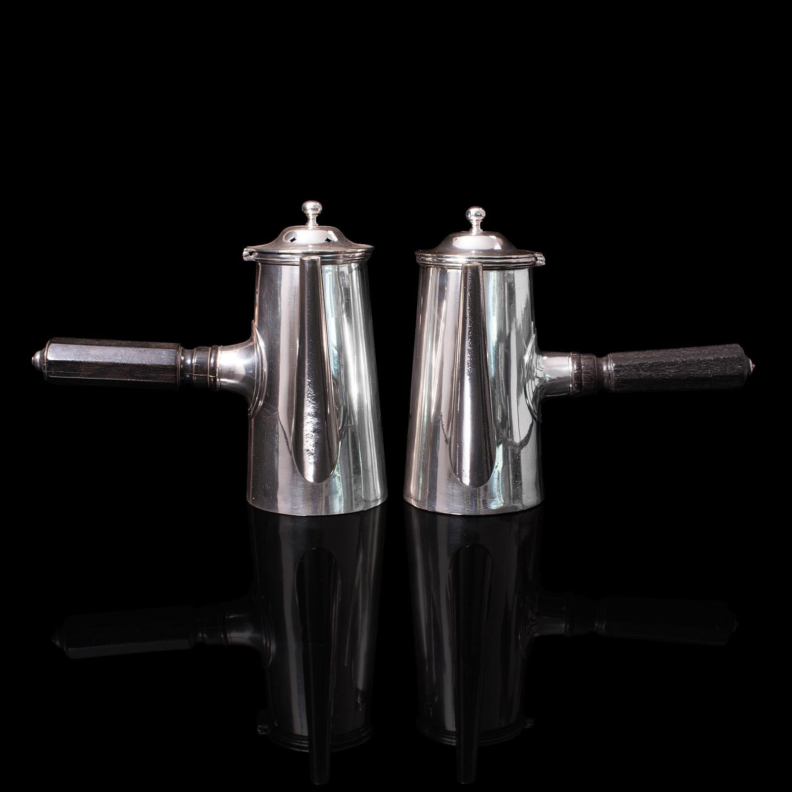 This is a matched pair of vintage coffee pots. An English, silver plated chocolate heating jug by Mappin & Webb, circa 1940.

Superb 2 pint specimens, as good to use today as 80 years ago
Displays a desirable aged patina and in good