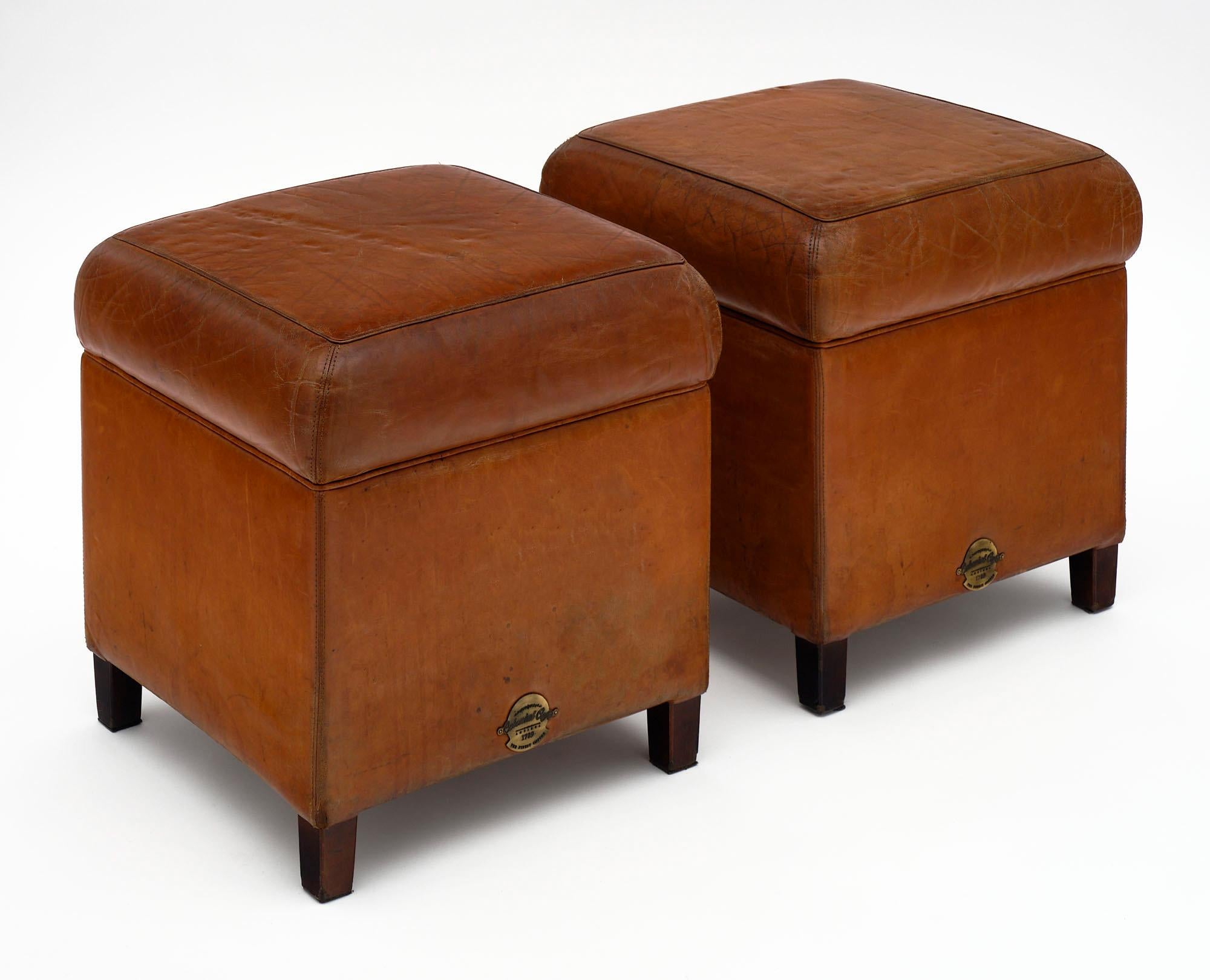 Pair of stools or ottomans made of patinated tan leather from iconic “Colonial Caffe 1789” in Milan, Italy.