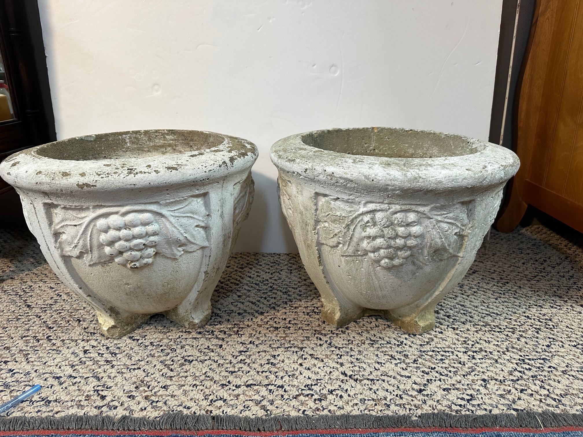 Jolie paire de jardinières en béton avec un décor de grappes de raisin en relief et des pieds évasés.  Diamètre d'ouverture 11,75