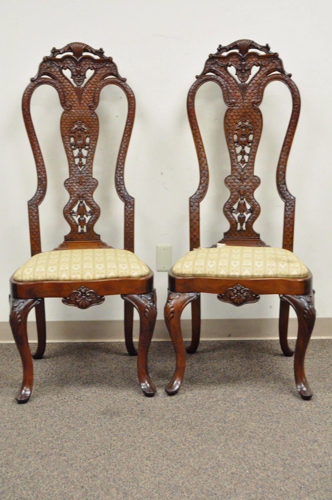 Pair of vintage solid mahogany continental style side chairs. Item features carved solid mahogany frames, tall dragon/reptile scale backs, cabriole legs, pad feet, drop seats, great quality and overall form, circa mid-20th century. Measurements: