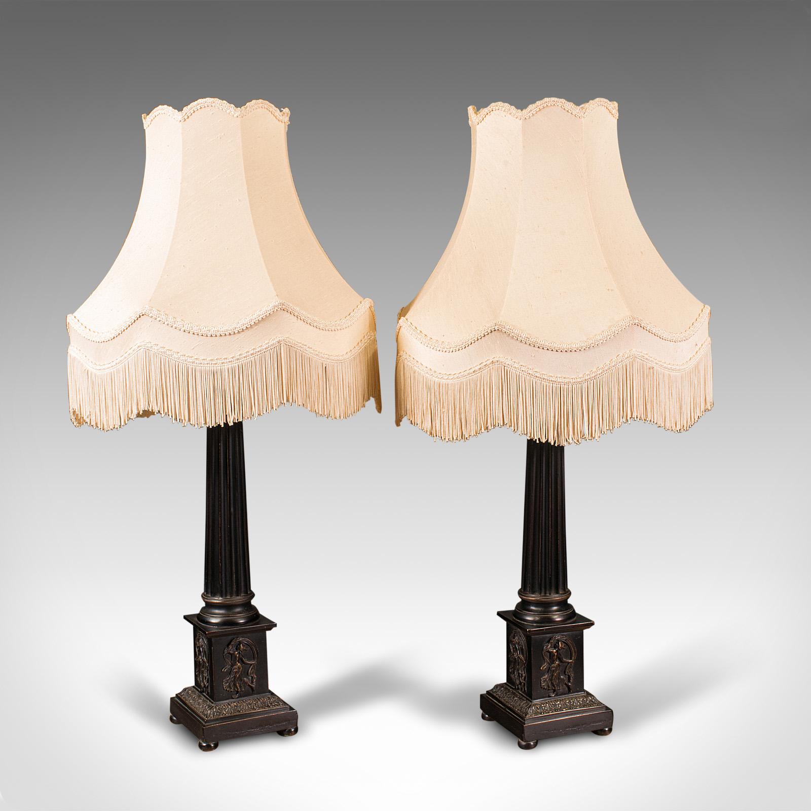 This is a pair of vintage Corinthian lamps. An English, faux cast bronze table lamp with classical taste, dating to the late 20th century.

Of generous proportion, with distinguished Corinthian column base
Displays a desirable aged patina and in