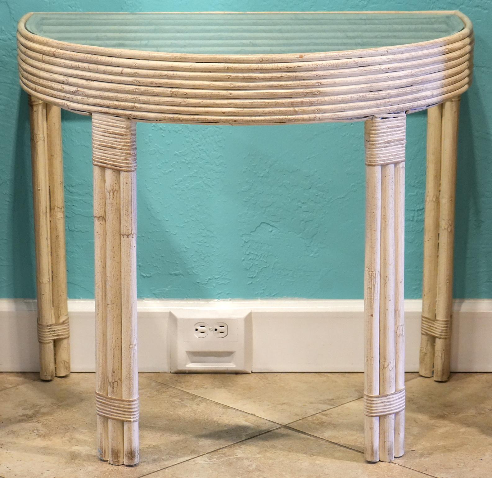 Of a great design and color these console tables exudes a timeless quality that will fit into any modern or traditional interior. The tempered class tops rest on a frame featuring bent reed on both sides and supported by three piece wrapped bamboo
