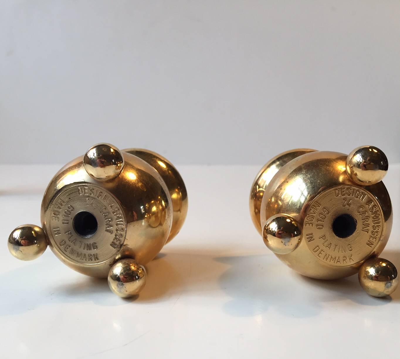 This set of two small cauldron-shaped 24-karat gold-plated candle holders was designed by Hugo Asmussen and manufactured by Asmussen in Denmark in the 1960s. Despite their small size, the candle holders require regular sized candles.