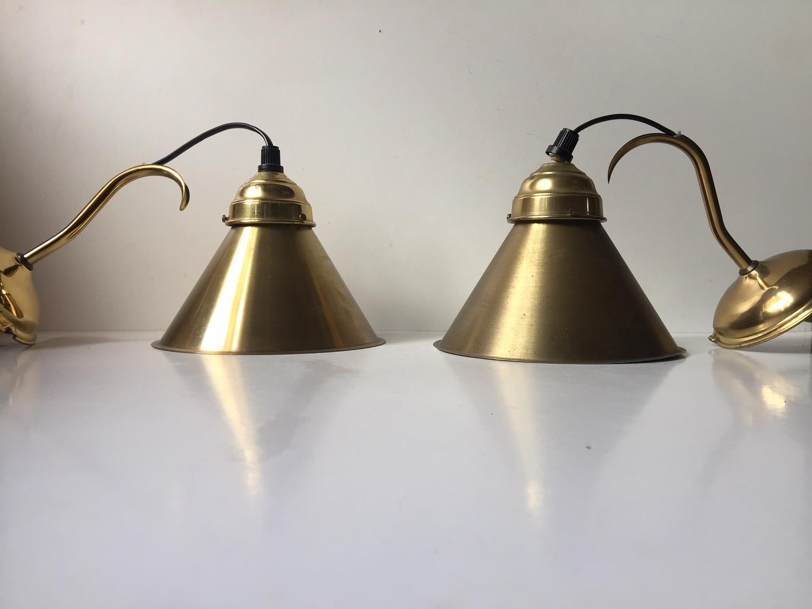 A pair of suspended wall lamps made from brass. They features loose hanging and height adjustable shades. Manufactured and designed by Danish Design, Giftline in Denmark during the 1970s.