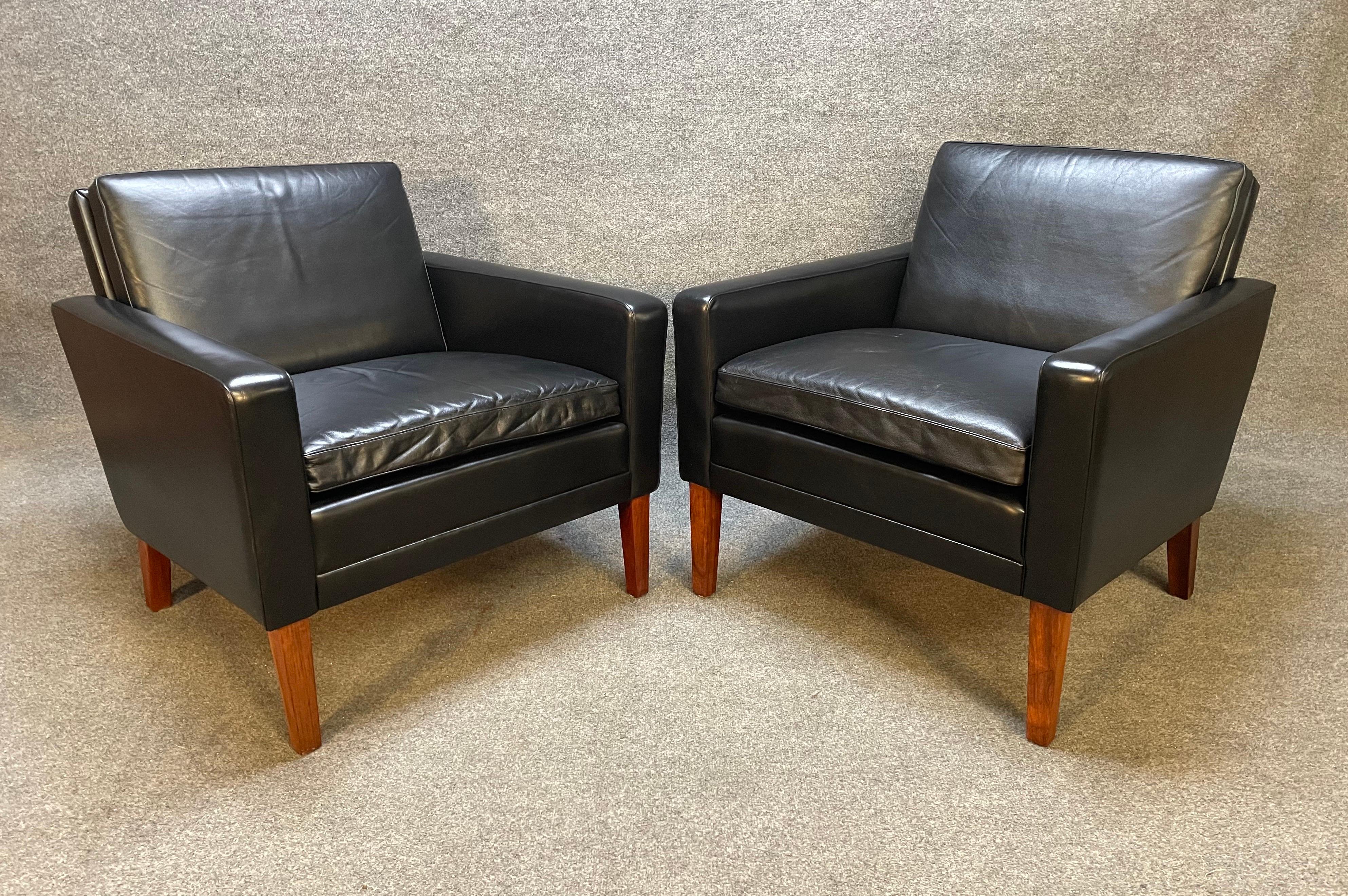 Here is a beautiful pair of 1960's Scandinavian club chairs in leather and rosewood recently imported from Denmark to California.
These two comfortable club chairs feature a full grain original patined black leather upholstery with solid rosewood
