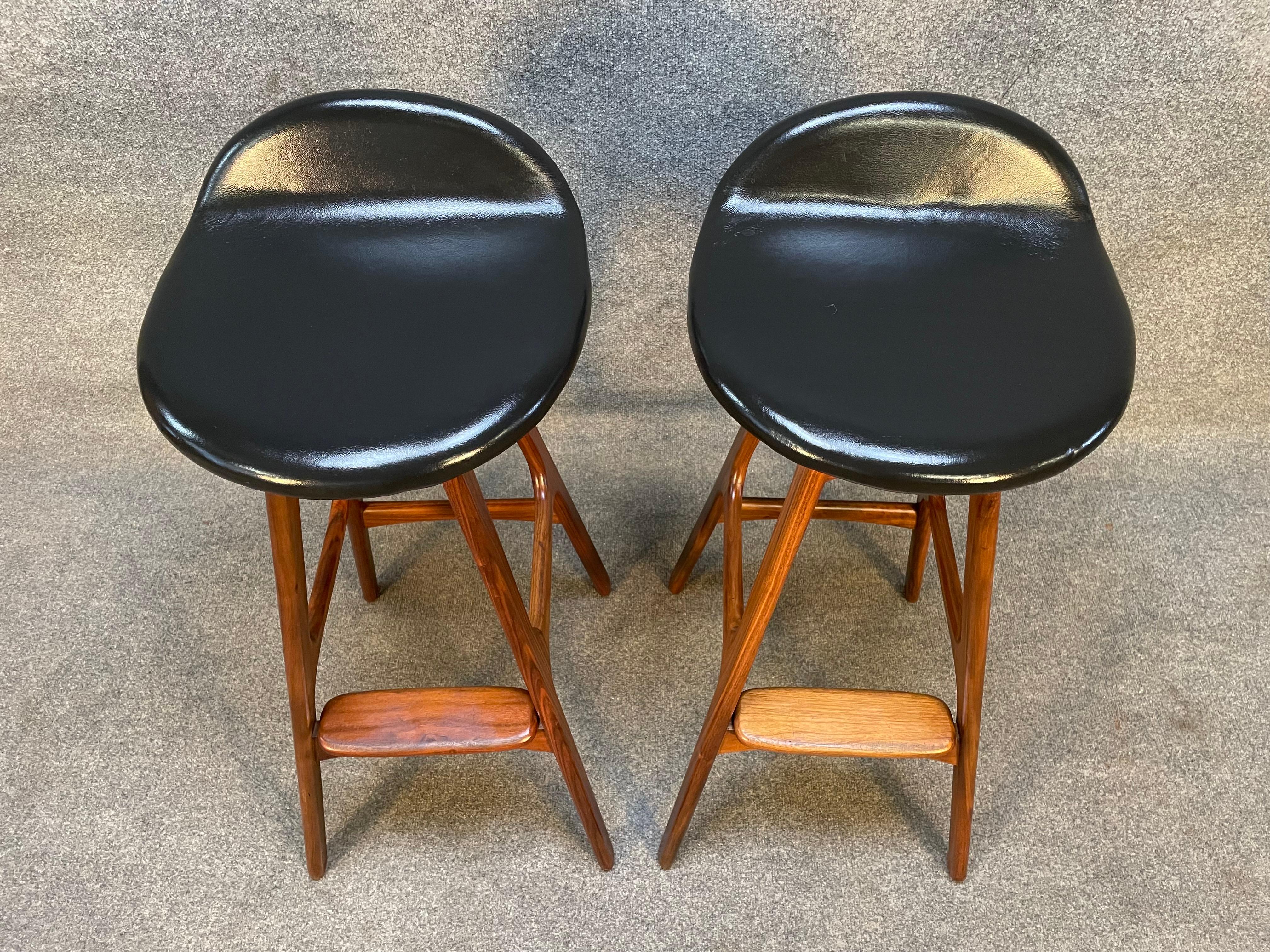 Here is a set of pair Scandinavian Mid-Century Modern bar stool in solid walnut designed by Erik Buch and manufactured by Odense Mobeklfabrik in Denmark ion the 1960's.
These four comfortable stools, recently imported from Europe to California