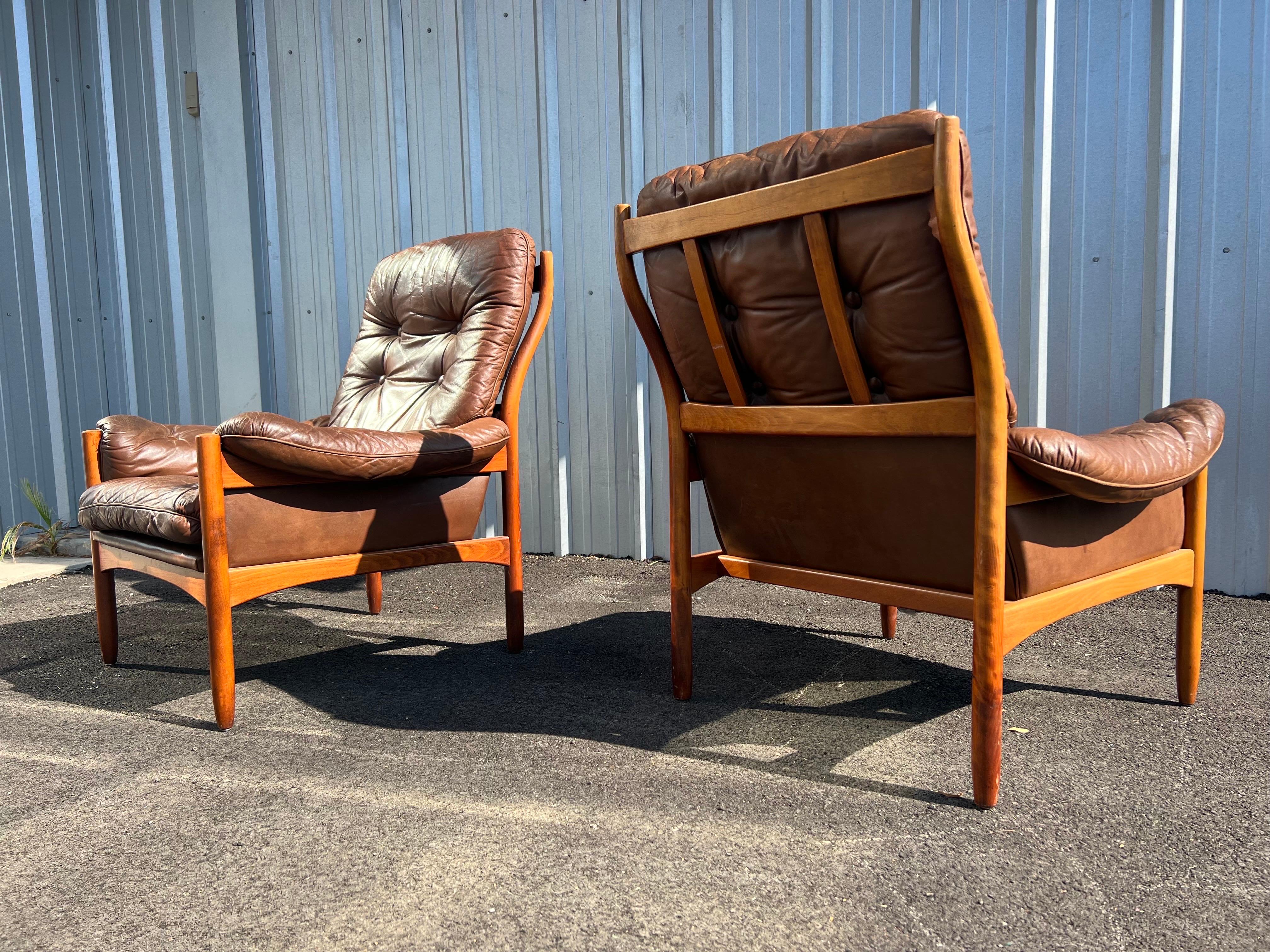 Pair of beautiful Danish modern leather lounge chairs designed by Göte Möbler Nässjö, Sweden, circa 1970s. Leather is a mocha color and the frame is made of Beechwood. There is slight wear on the arms and some wear on the back of the frame located