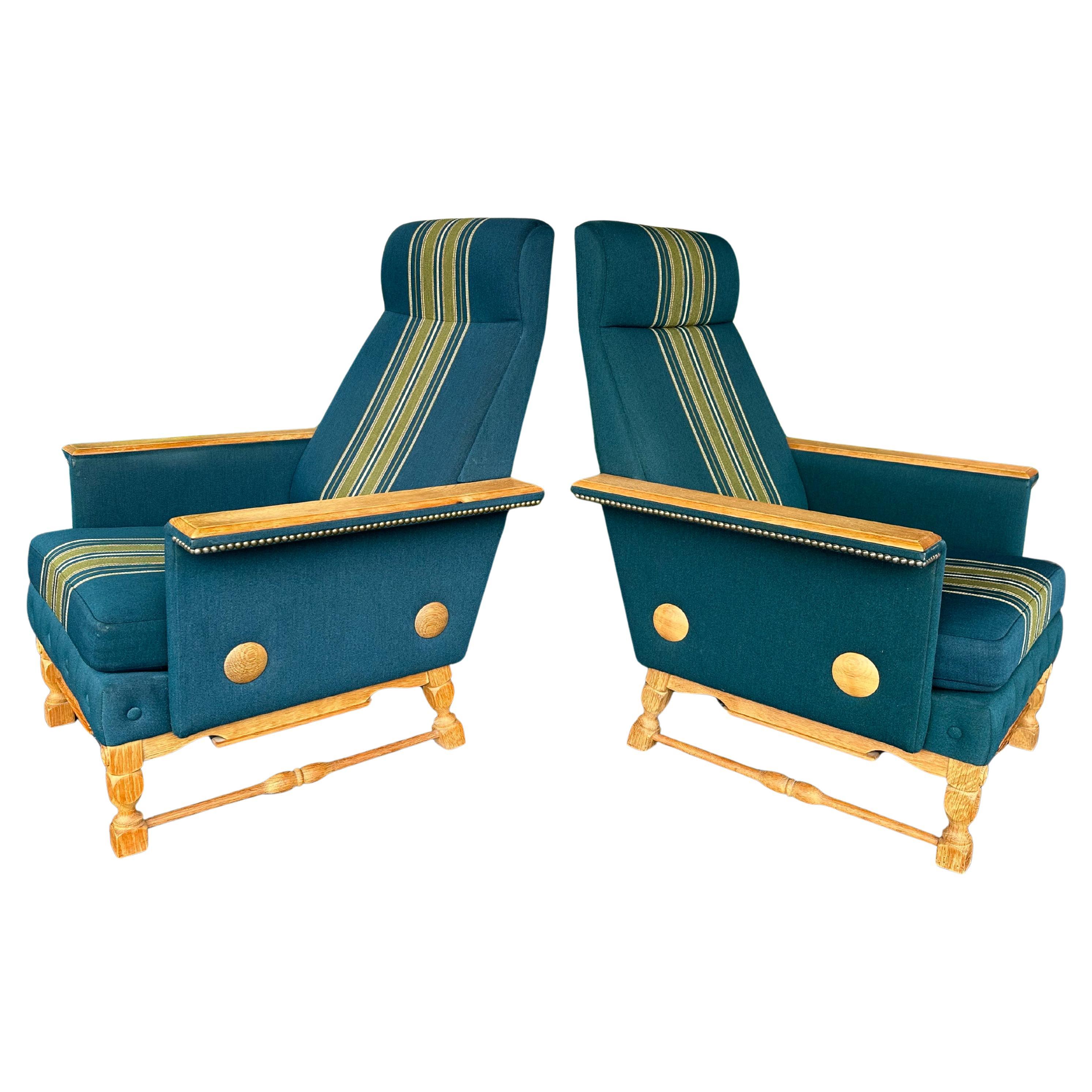 Pair of Danish Mid Century High Back Lounge Chairs in Oak and Teal Striped Wool Upholstery. Styled after Henning Kjaernulf Circa 1970’s, carved oak sled bases, oak armrests and whimsical oak circle detailing at sides. Nail heads adorn arms and