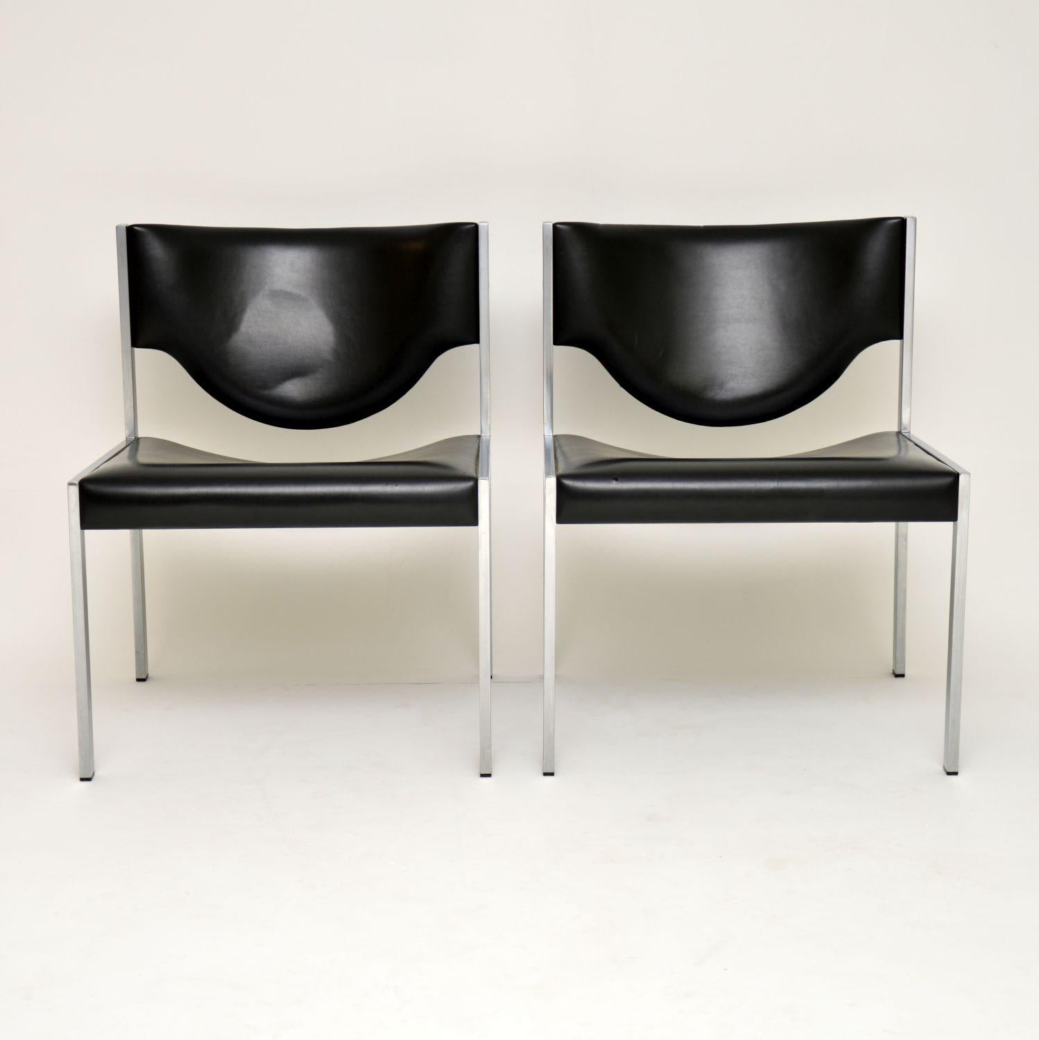 A stylish and very comfortable pair of lounge chairs, beautifully made with polished steel frames and black vinyl upholstery. They date from the 1960s, and are in great condition for their age. The steel frames are all clean, sturdy and sound, with