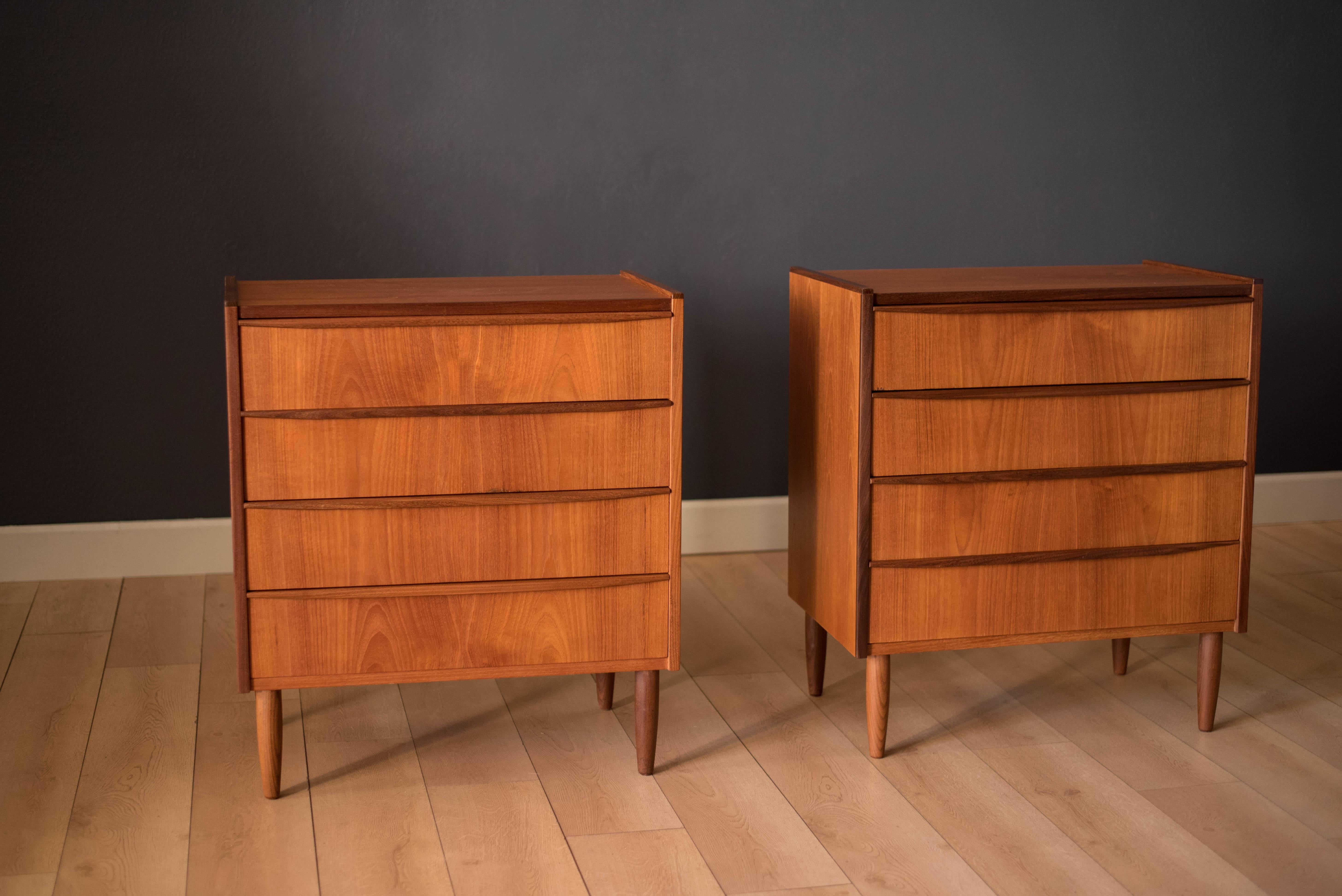 Mid-Century Modern pair of dresser chests in teak marked made in Denmark. Each dresser includes four drawers with sculpted handles and dovetail construction. Price is for the pair.