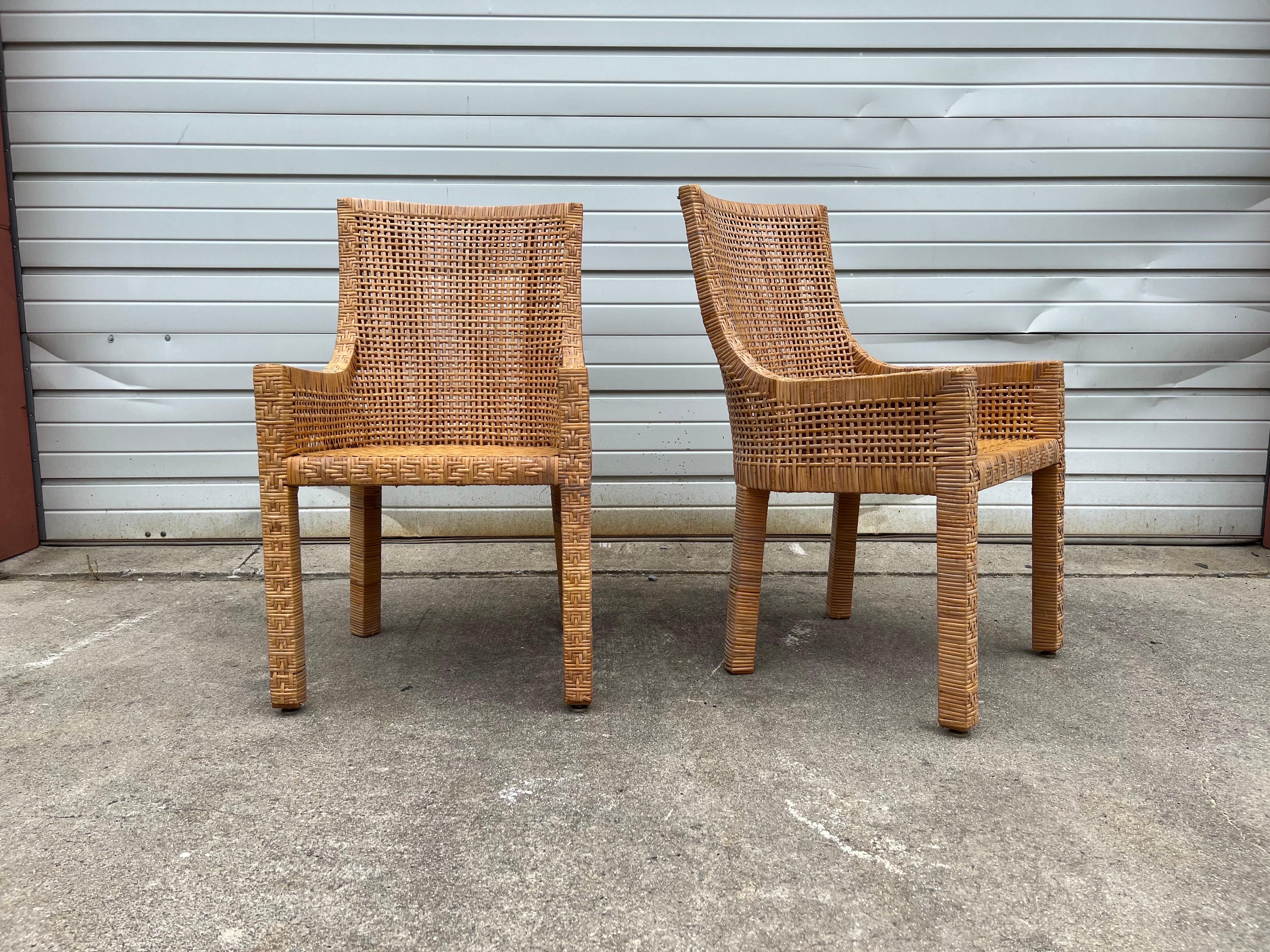 Beautiful pair of vintage wood and rattan chambered arm chairs in the manner of Danny Ho Fong. Upholstered cushions optional with snap buttons concealed on the back.  Great vintage condition and ready for a statement or a new pop of fabric or