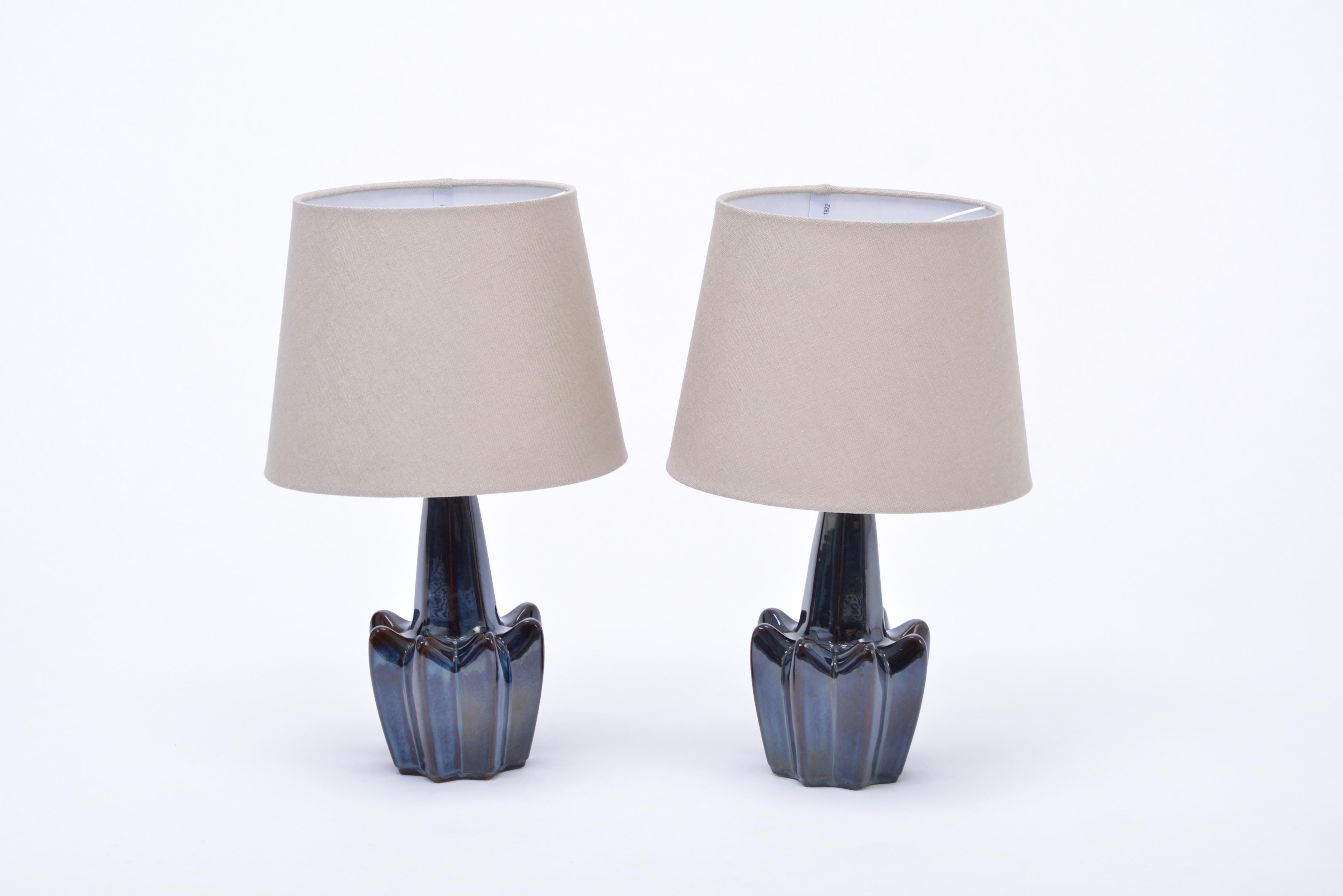 Pair of Mid-Century Modern dark blue Stoneware table lamps model 1046 by Soholm

Pair of dark blue table lamps made of stoneware with ceramic glazing. Produced by Danish company Soholm. The lamps have been rewired for European use and have new