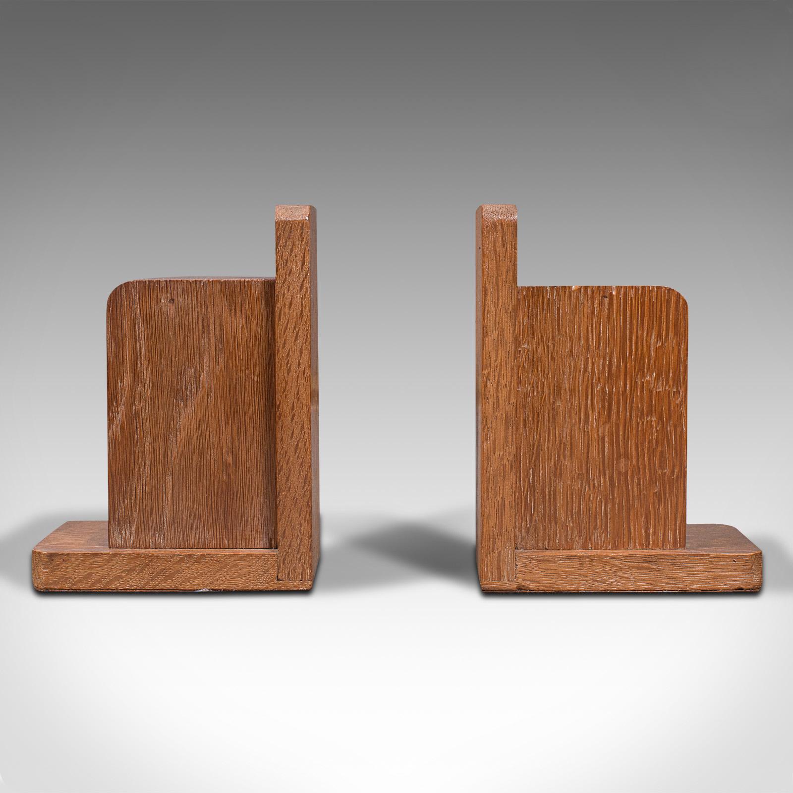 This is a pair of vintage decorative bookends. An English, light oak book rest in the manner of Liberty, dating to the Art Deco period, circa 1940.

Appealing forms inspired by the aesthetic of Heals and Liberty of London
Displaying a desirable