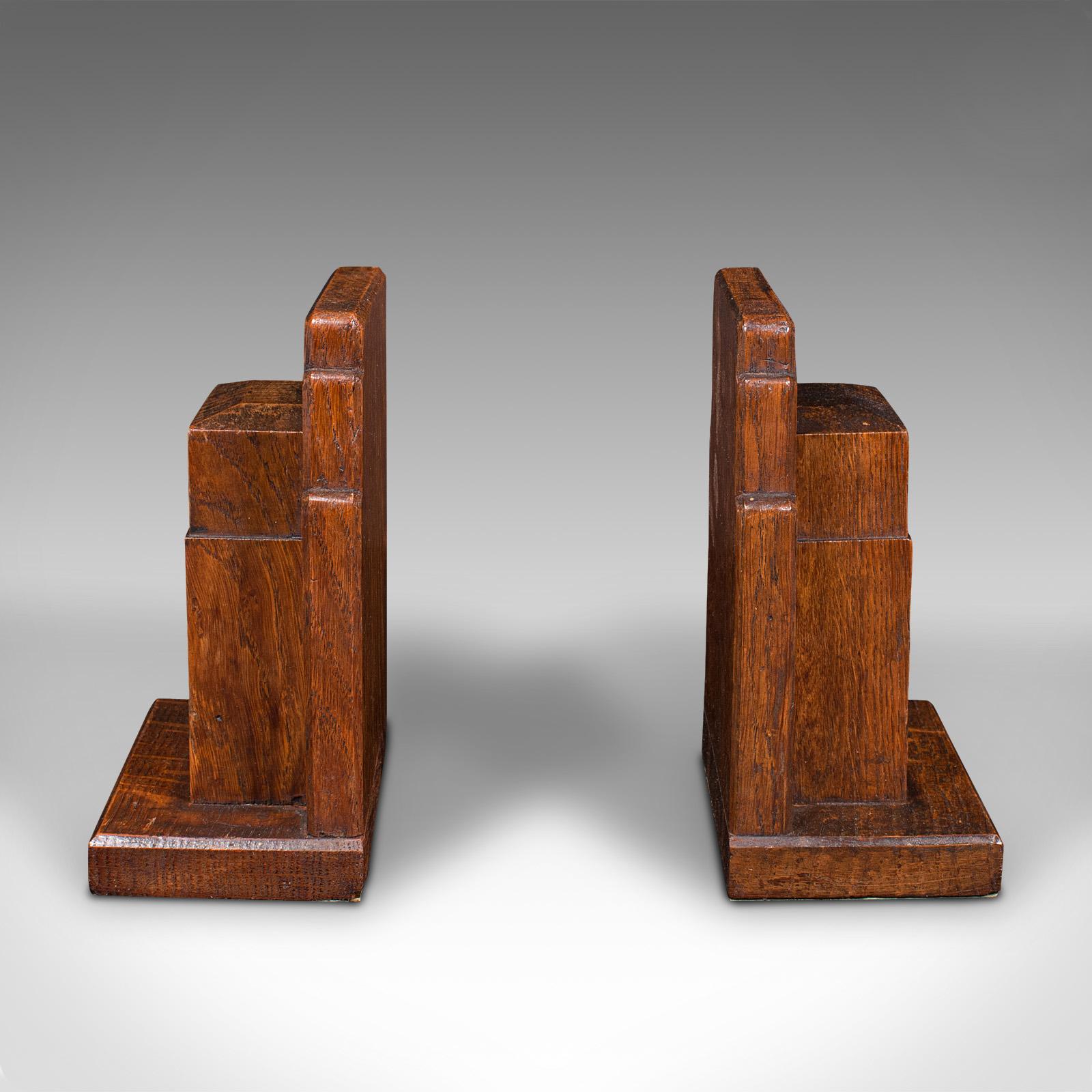 This is a vintage pair of decorative bookends. An English, oak book rest, dating to the early 20th century, circa 1930.

A charming bookend set, in the manner of George Russell's iconic taste
Displays a desirable aged patina and in good order