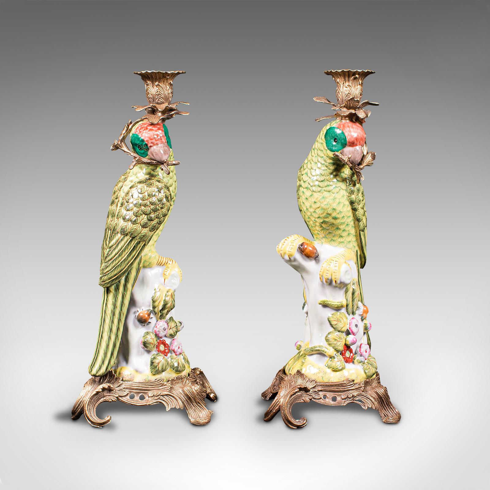 This is a fine pair of vintage decorative candlesticks. An Oriental, ceramic parakeet figure as a candelabra, dating to the late 20th century, circa 1980.

Rich in colour and character, the pair present beautifully
Displaying a desirable aged