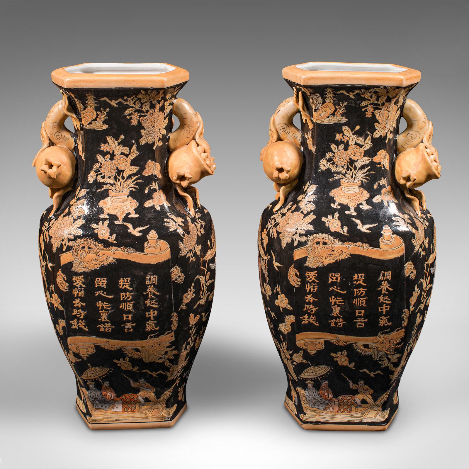 This is a pair of vintage decorative vases. A Chinese, ceramic tourist ware dried flower urn, dating to the late 20th century, circa 1980.

Strong Art Deco revival taste with distinctive black ground
Displaying a desirable aged patina and in good
