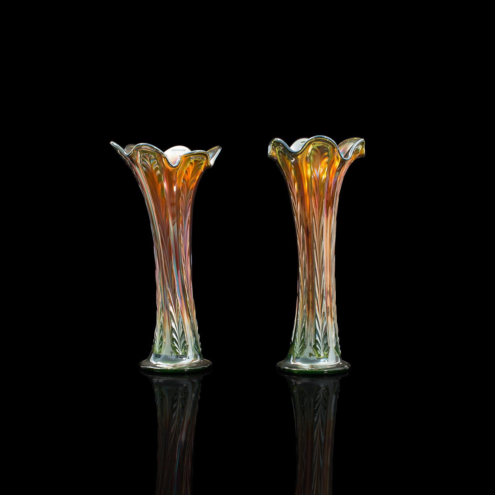 This is a colorful pair of vintage decorative vases. An English, carnival glass flower vase with striking lustre finish, dating to the mid 20th century, circa 1960.

Dashing fluted vases with appealing colouration
Displaying a desirable aged