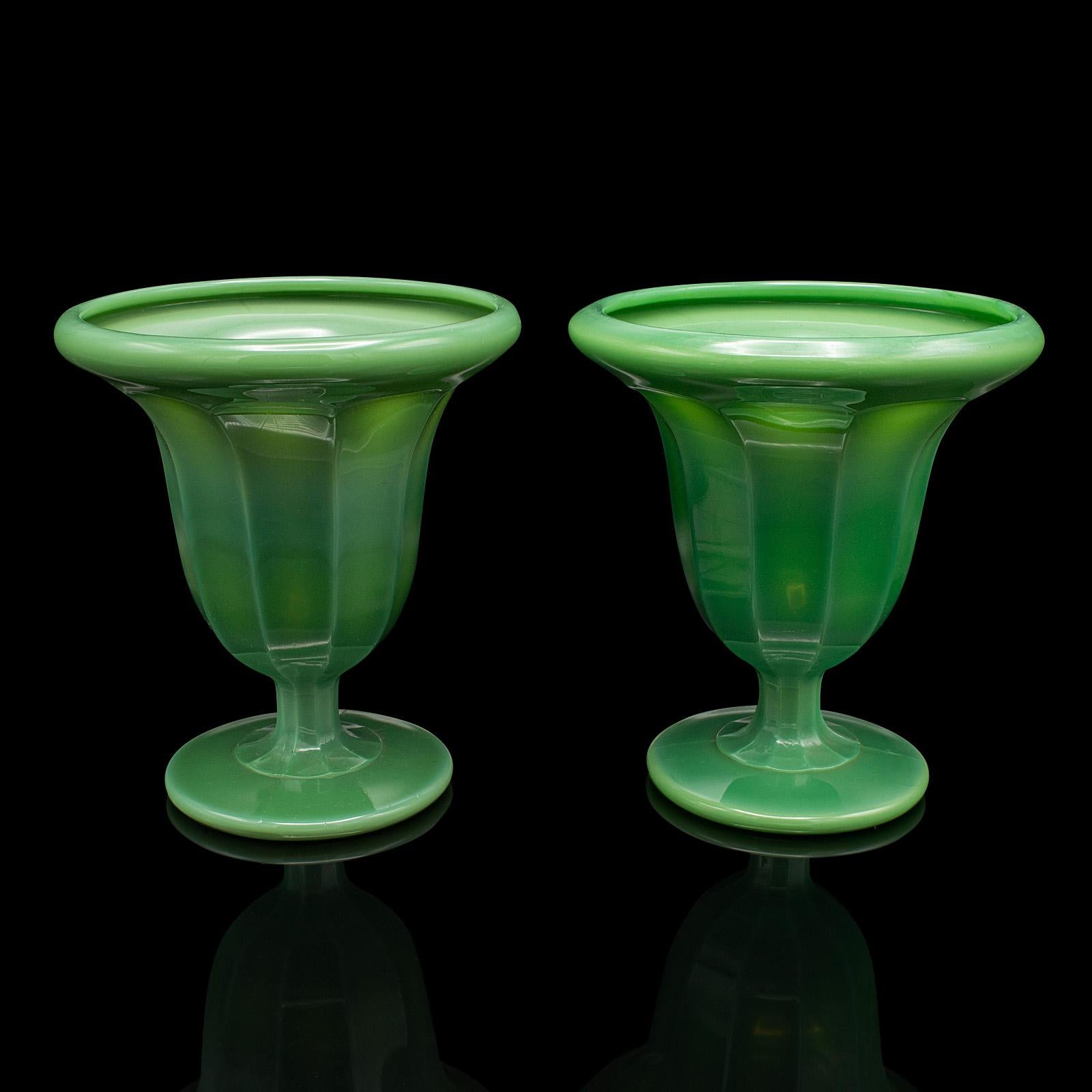 
This is a pair of vintage decorative vases. An English, cloud glass plant pot, dating to the Art Deco period, circa 1930.

Unusual glass finish with a distinctive green hue
Displays a desirable aged patina and in good order
Green cloud glass with a