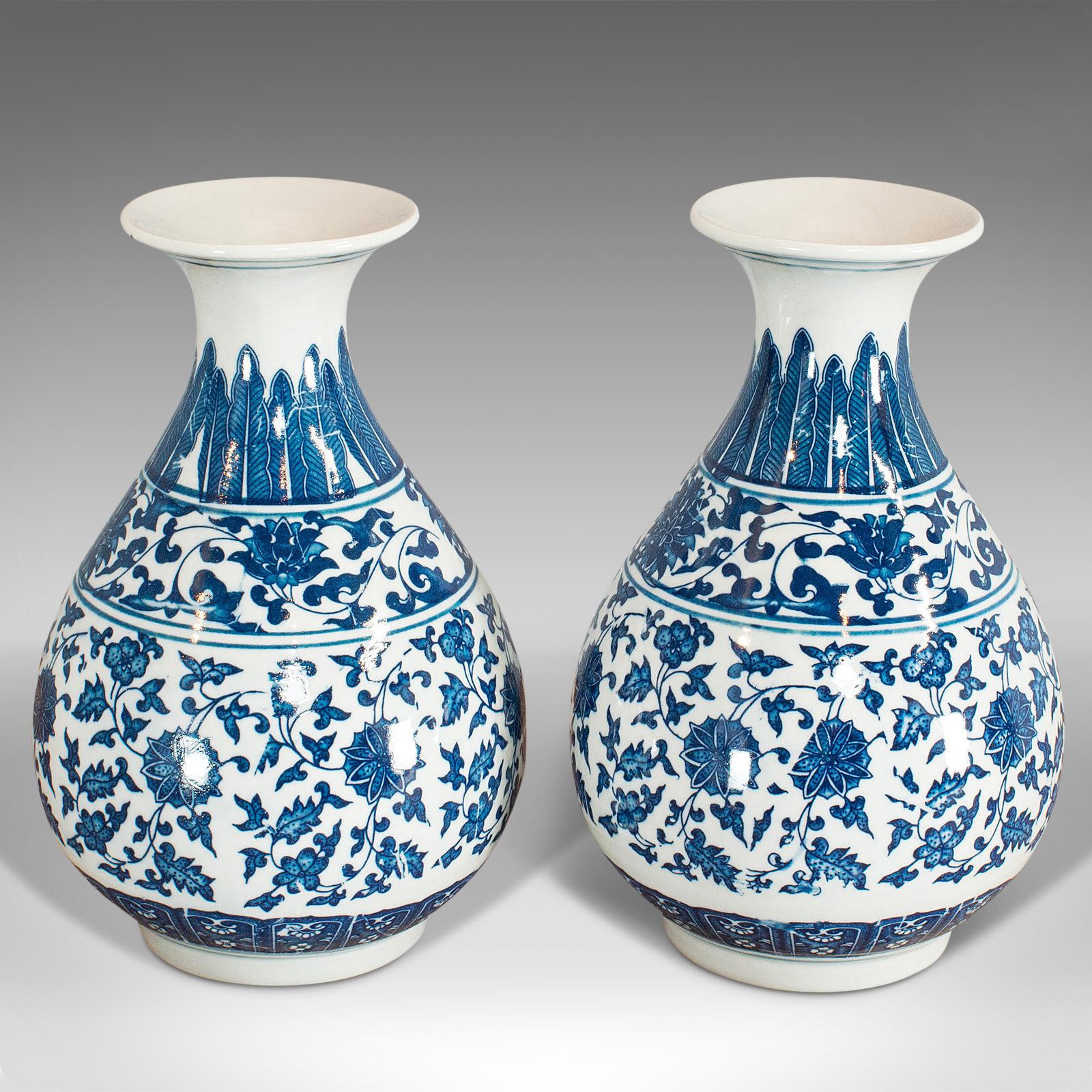 This is a pair of vintage decorative vases. An Oriental, ceramic baluster urn with painted detail, dating to the late 20th century, circa 1990.

Attractive vases with good detail
Displays a desirable aged patina
Ceramic in good order