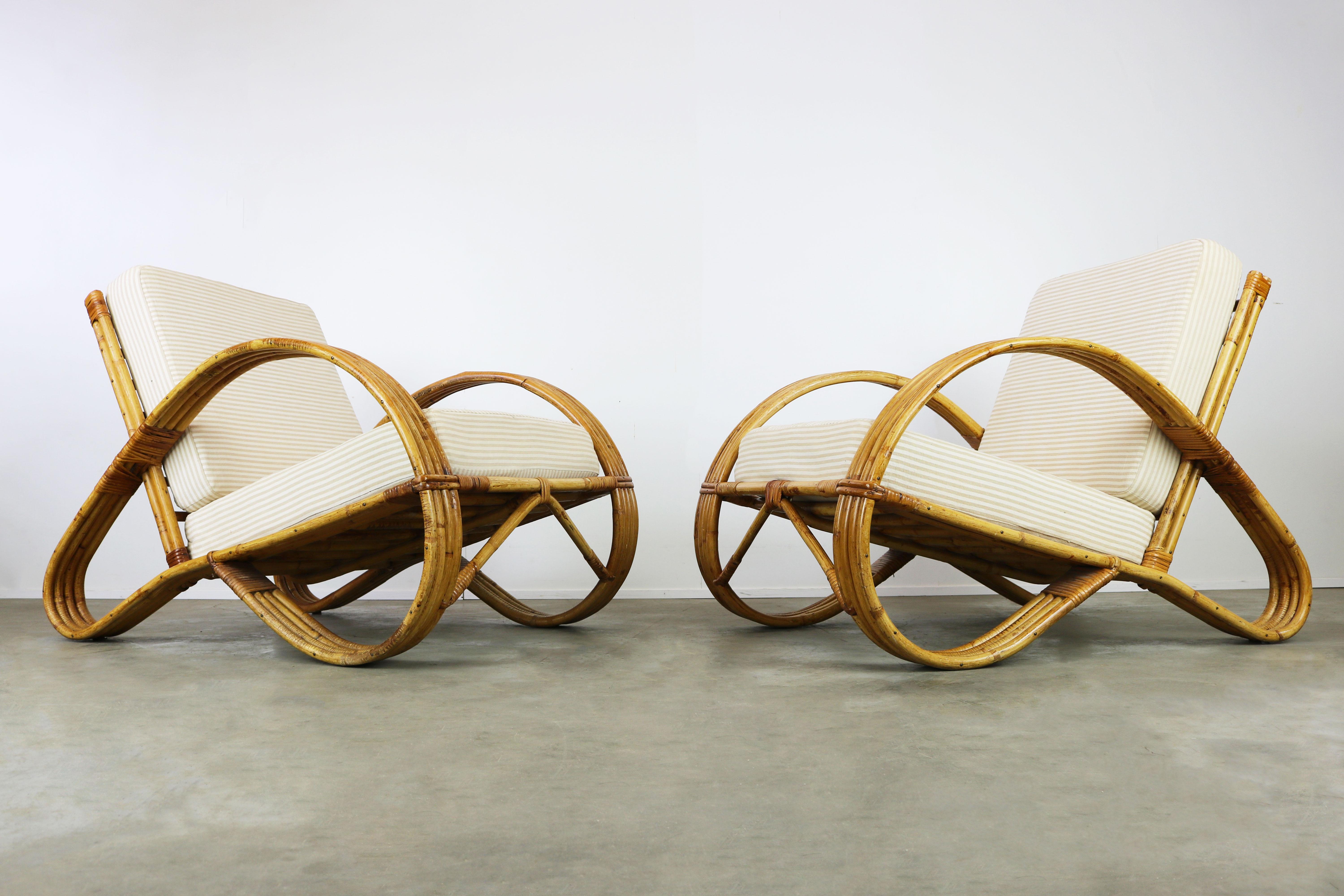 Rare pair of early 1950s rattan lounge chairs designed by Dutch designer Rohe Noordwolde in the early 1950s. De lounge chairs have a wonderful and appealing shape; they are fully made of rattan. Very firm and heavy quality, and very comfortable. The