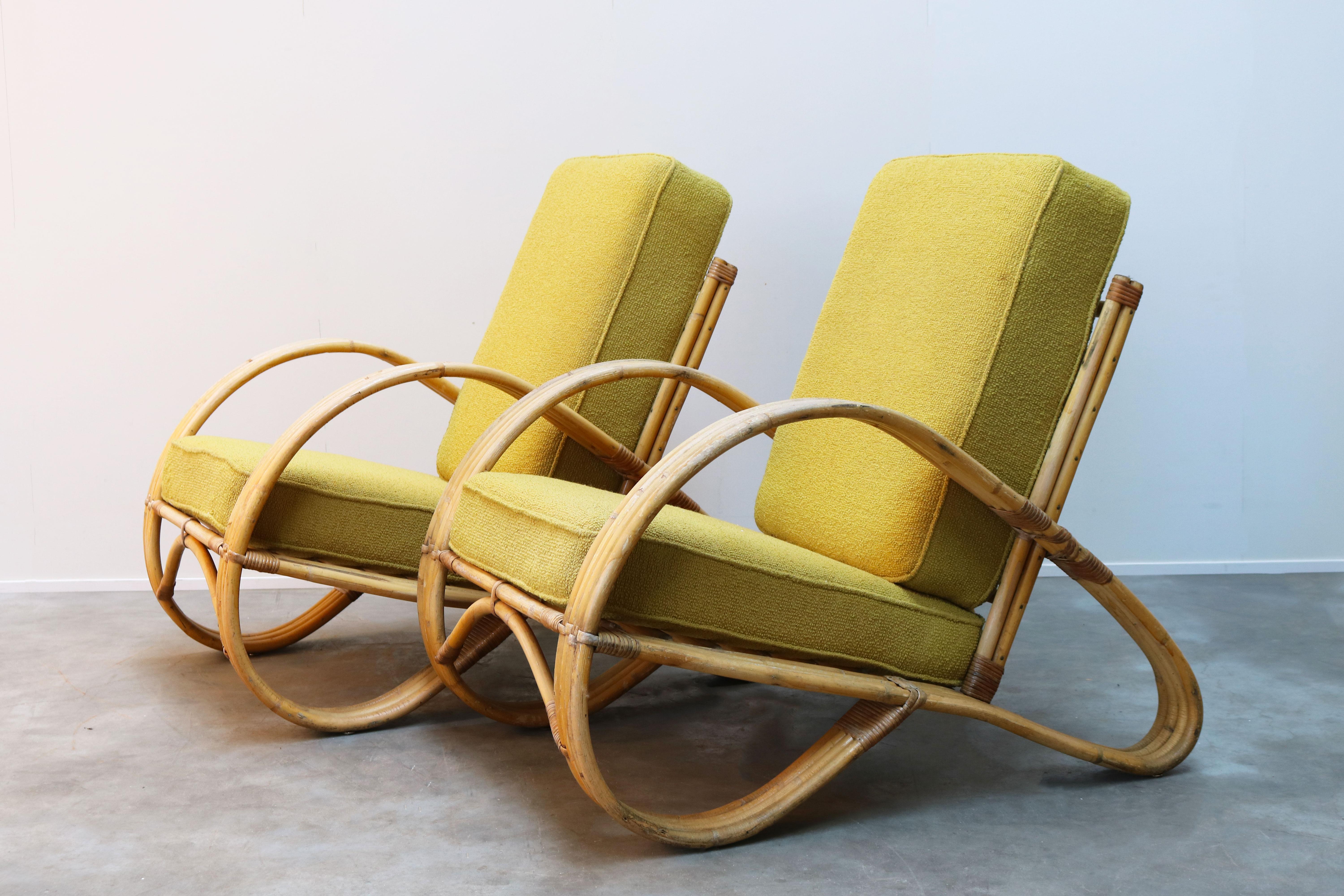 Rare pair of early 1950s rattan lounge chairs designed by Dutch designer Rohe Noordwolde in the early 1950s. De lounge chairs have a wonderful and appealing shape; they are fully made of rattan. Very firm and heavy quality, and very comfortable. The