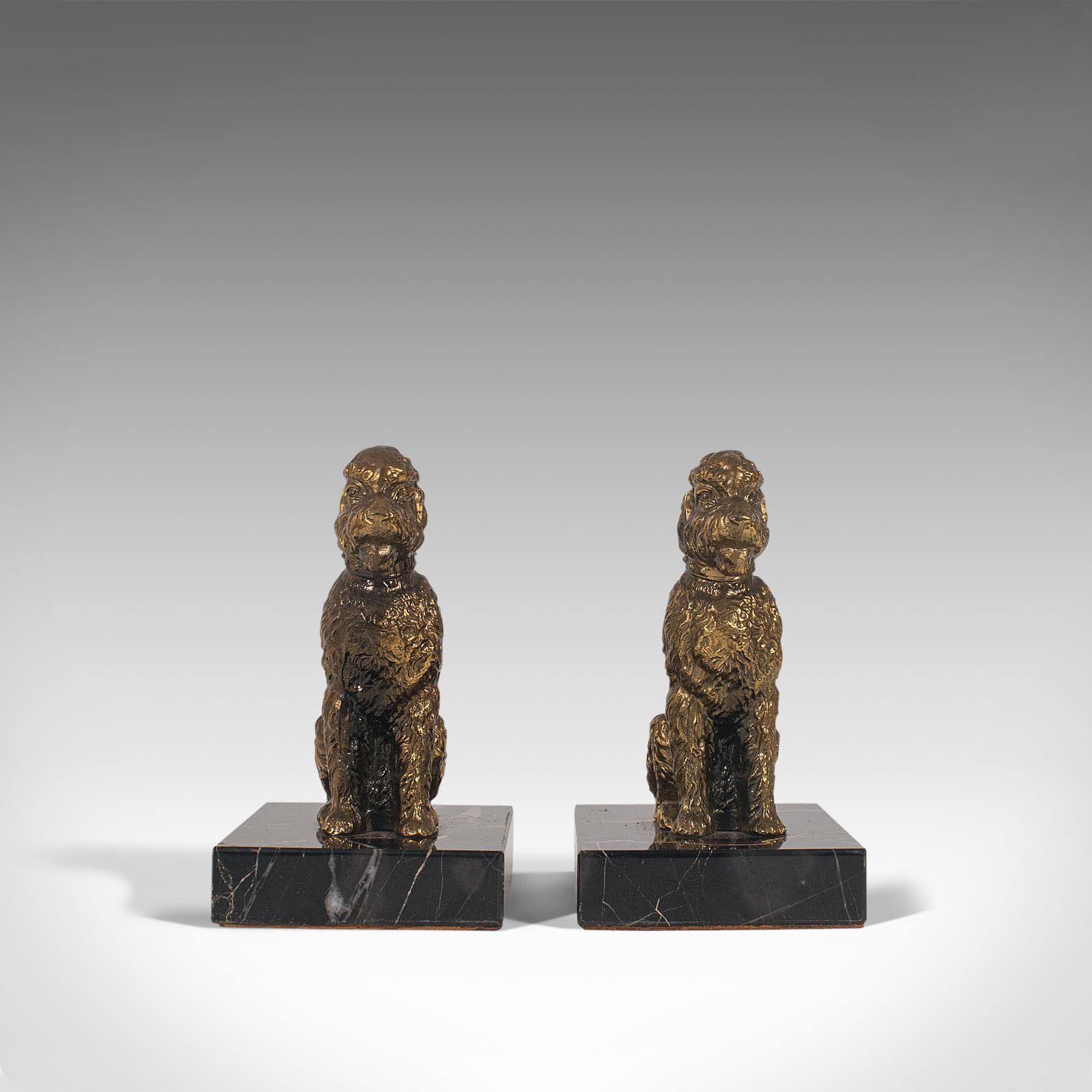 This is a pair of vintage dog figures. An English, gilt metal study of the loveable Airedale Terrier upon a marble base, dating to the late 20th century, circa 1980.

Faithful friends cast in decorative form
Displaying a desirable aged patina,