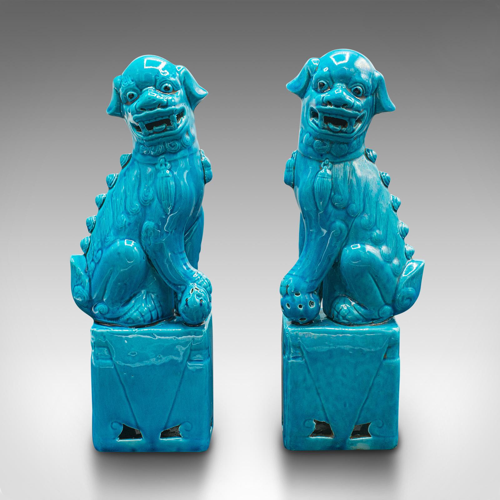This is a pair of vintage dog statues. An Oriental, ceramic decorative 'Dog of Fo' ornament dating to the late Art Deco period, circa 1940.

Captivatingly blue dogs with fine finish and appearance
Displaying a desirable aged patina and in good