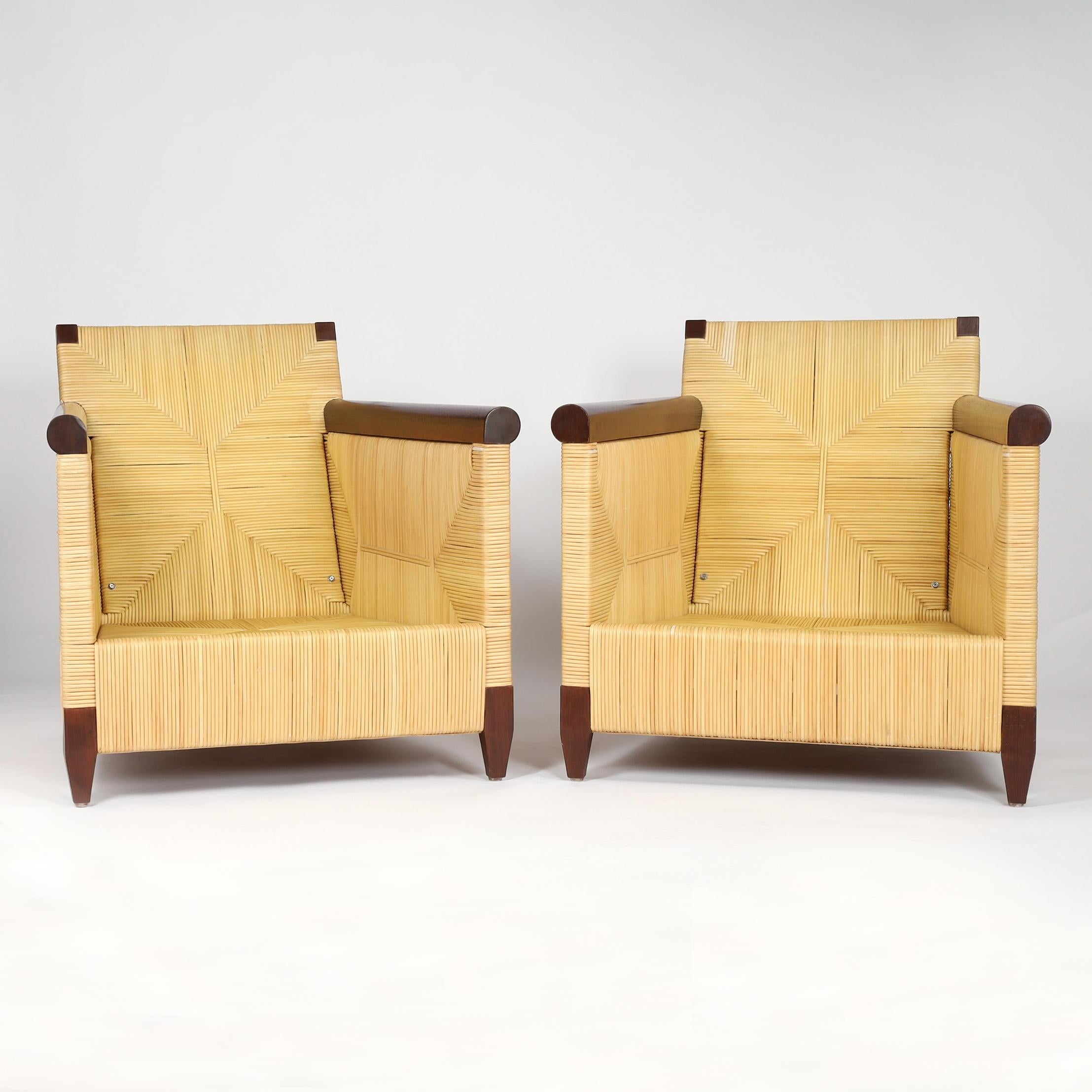 Elegante par de tumbonas de ratán tejido con brazos y patas de caoba y tapicería de imitación de leopardo. Diseñado por John Hutton para la Colección Merbau de Donghia. Grabado Donghia en los fondos. 

H: 30 A: 30 D: 35,5
Altura del asiento con